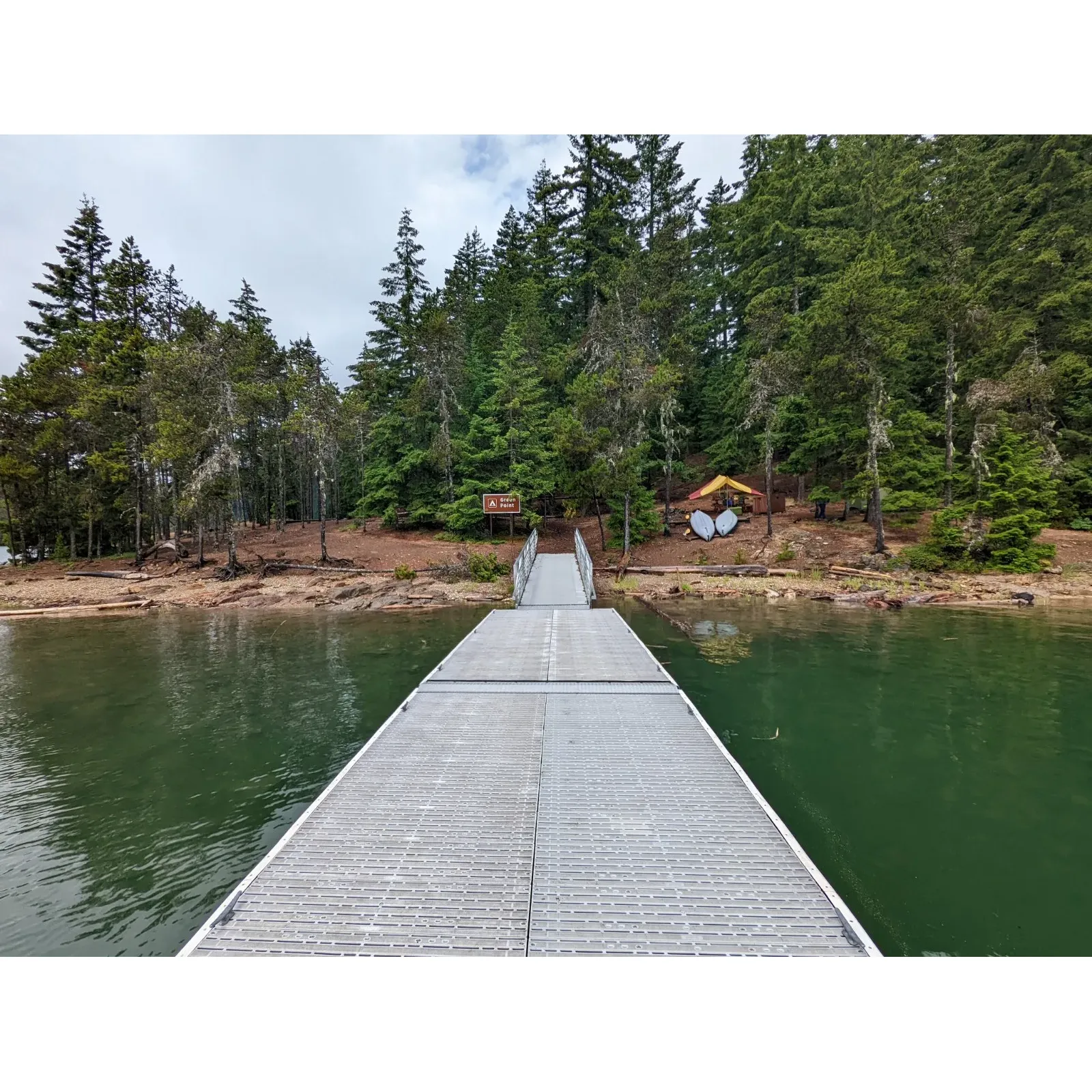 Green Point Campground beckons outdoor enthusiasts with its idyllic location set on a picturesque peninsula surrounded by the serene waters of Ross Lake and framed by majestic mountain vistas. Campers are treated to a trifecta of carefully designated spaces that provide all the necessary amenities for a comfortable stay, including picnic benches and secure storage lockers to enhance their outdoor experience.

The campground is a haven for relaxation, offering the perfect environment for hammock enthusiasts to sway in tranquility while soaking in the panoramic views of the lake and mountains. The harmonious atmosphere at Green Point serves as a peaceful escape from the bustle of daily life, allowing visitors to unwind in the lap of nature.

Boasting an excellent group camp, Green Point is an ideal choice for those seeking to share their adventure with friends or family. The eastern shore of Ross Lake presents an awe-inspiring backdrop that can be admired from the comfort of the camp, or explored via hiking trails or boat.

For avid hikers, Green Point Campnearound represents an exciting destination to aim for, promising the allure of a future camping trip amidst the natural beauty. With its combination of scenic beauty, well-maintained facilities, and a sense of tranquil seclusion, Green Point Campground is truly a camping spot that promises unforgettable outdoor experiences. Description by ChatGPT.