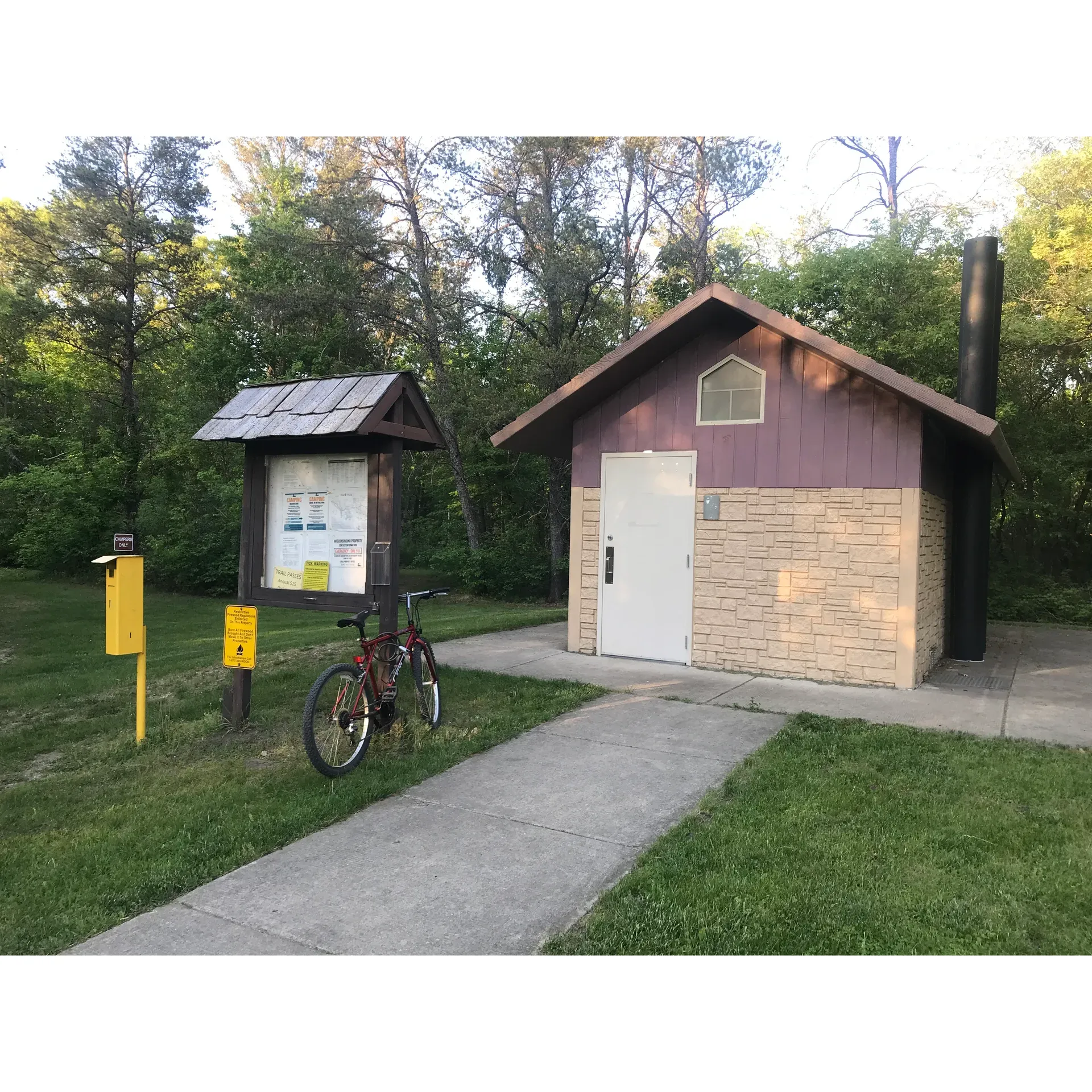 Strategically positioned along the scenic route from Camp Douglas to Elroy and onward to Sparta, Sparta DNR Campground offers a convenient and budget-friendly outdoor retreat for both solo explorers and group adventurers. Each site can be easily reserved online, providing a streamlined registration process to secure a spot for an affordable fee complemented by a minimal service charge. With group arrangements, the value becomes exceptionally evident, dispensing an economical solution for shared outdoor experiences.

The campground presents a quintessentially rustic atmosphere with its lush wooded surroundings, perfect for those seeking an authentic camping experience. Visitors can look forward to the essential amenities such as fresh water sources, with at least one fountain reliably operational, and vault-style restrooms ensuring basic comforts are at hand. Every campsite is furnished with a picnic table, inviting campers to relish their meals amidst nature.

Diversity in terrain characterizes the various campsite options, with some offering sandier and drier grounds, catering to different preferences and weather conditions. Although proximity to the interstate hints at accessibility, the wooded buffer does its part in maintaining a sense of tranquility within the campground.

Biking enthusiasts will find themselves at the heart of adventure, as the campground boasts immediate access to the revered trails, complete with historic tunnels that promise an unparalleled biking journey. The experience is deemed a must-visit for cyclists looking to immerse in the beauty of the region.

For those who seek seclusion, certain areas of the campground are particularly well-suited for a serene night under the stars. While some sites offer a more refined experience, the campground embraces a pristine natural vibe across its landscape.

Sparta DNR Campyard beckons as an idyllic base for campers and cyclists alike, offering a blend of convenience, adventure, and natural beauty for a memorable outdoor sojourn. Description by ChatGPT.