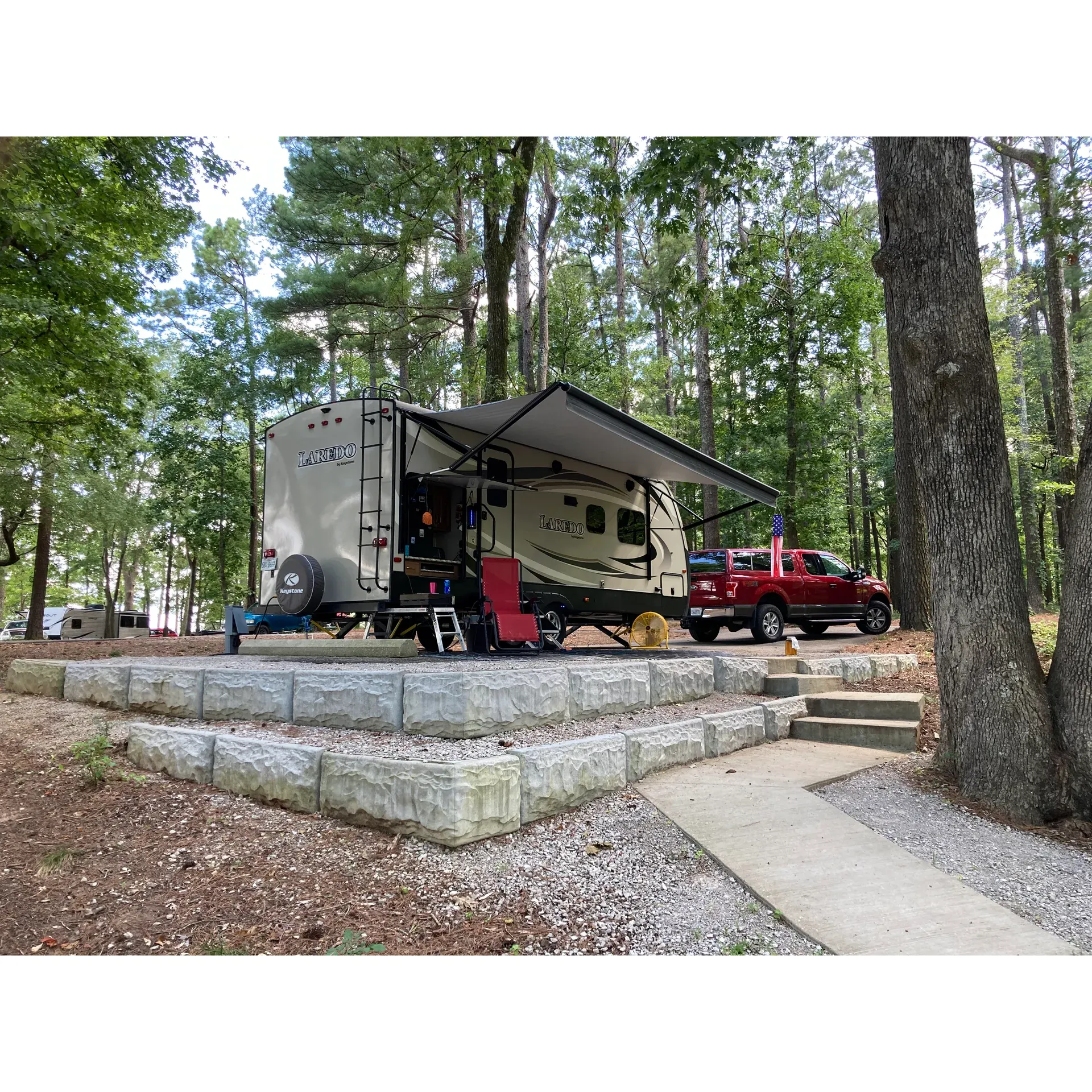 Piney Grove Campground offers an exceptional outdoor experience, providing visitors with a tranquil retreat that showcases the beauty of Mississippi's natural landscapes. Managed by a dedicated and wonderful team, the campground maintains the highest standards of cleanliness, ensuring a spotless environment that enhances your stay.

The campground features an expansive green space that invites guests to connect with nature and engage in rejuvenating activities. Amidst the picturesque scenery, guests can find themselves at campsite 17, which boasts an awe-inspiring lake view complemented by plenty of shade. This premium site offers a comprehensive camping package including a picnic table, high-top cement table, fire pit, grill, and hanging pole, all arranged within a neat gravel courtyard for your convenience.

The campground's host is known for their friendliness, offering a warm welcome and smooth check-in and check-out processes for all guests. Accessibility is a key feature here, with easy entry and exit points that make your stay hassle-free.

While Piney Grove Campground is designed to accommodate various camping preferences, particular attention has been given to the preservation of the site's tranquility, making it the perfect getaway for those seeking peace and solitude. Its location, away from the hustle and bustle of city life, ensures that guests can soak in nature's splendor and enjoy moments of quiet reflection.

Outdoor enthusiasts will be pleased to discover that the campground includes two distinct camping areas and access to what many regard as a delightful beach, ideal for sun-filled leisure activities with family and friends. Though there are no individual sewer hookups at each site, the campground's dual dump station offers a convenient solution for all RV campers.

The campground can accommodate various types and sizes of camping equipment, and while some sites may present limitations for large rigs, there is a spot for everyone within this breathtakingly beautiful park. With the commitment to excellent service and maintenance, Piney Grove Campground stands out as a premier destination for anyone seeking to relish in nature's magnificence, all while enjoying the comforts and amenities of a well-structured camping site. Description by ChatGPT.