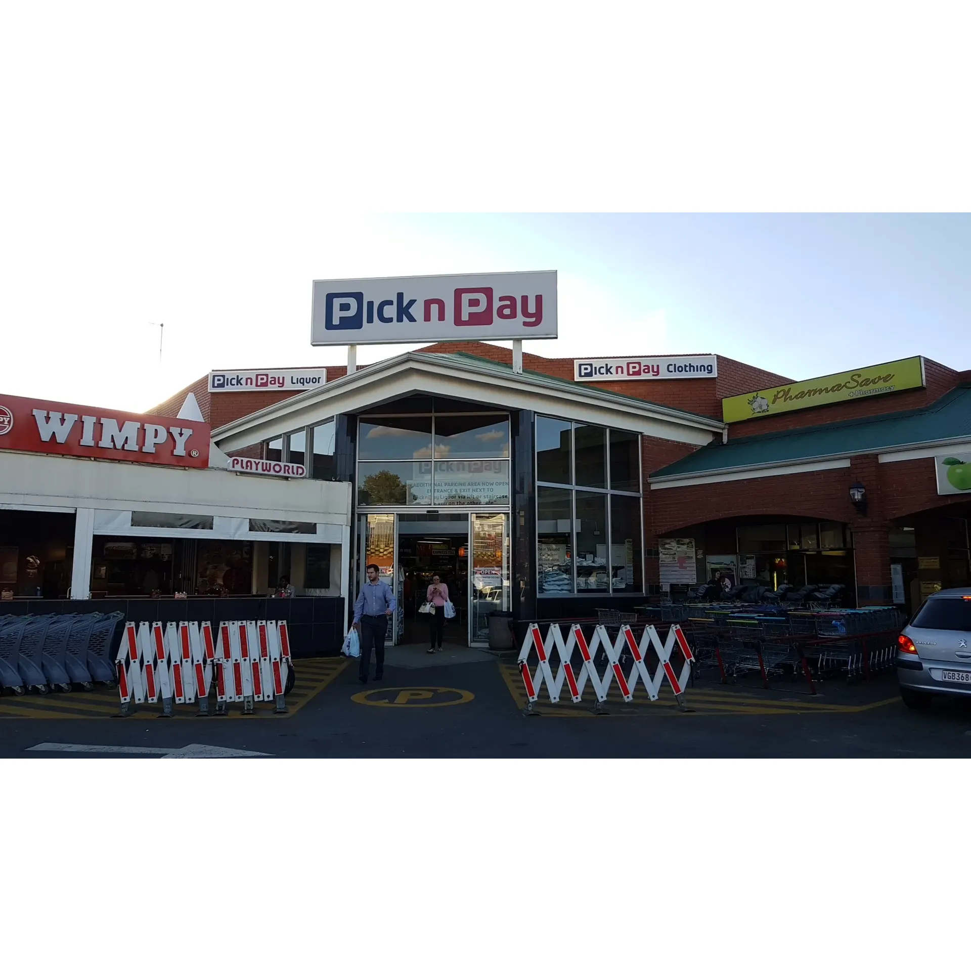 Pick n Pay Douglasdale offers a contemporary shopping experience in a recently revamped space, known for its wide selection of fresh foods and essential products. Customers appreciate the attentive and helpful management and the readily available stock that ensures a seamless and pleasant shopping trip.

A distinct highlight of Pick n Pay Douglasdale is the delightful café experience where shoppers can enjoy a cup of coffee with a variety of milk alternatives at no additional cost, catering to the preferences of vegan customers and those seeking dairy-free options. This inviting atmosphere presents an opportunity for patrons to unwind, potentially prolonging their visit which is both beneficial for the store and enjoyable for the shopper.

The store makes a concerted effort to support the community's needs, offering convenience and proximity as its asset. Sipho, the store manager, is known for his supportive and problem-solving approach, continuously striving for an improved customer experience at the local level while aligning with the broader regional management directives.

Additionally, customers can indulge in culinary delights like the renowned boerewors rolls, which are reputed for being exceptionally well-prepared. The friendly staff member attending to the grilling station delivers not only mouth-watering food but also exceptional service with a personal touch, happily accommodating customer preferences with a warm and welcoming smile.

The positive atmosphere, combined with the commitment to customer care and a diverse product range, ensures that Pick n Pay Douglasdale continues to be a preferred destination for daily shopping needs and cozy café sips. Description by ChatGPT.