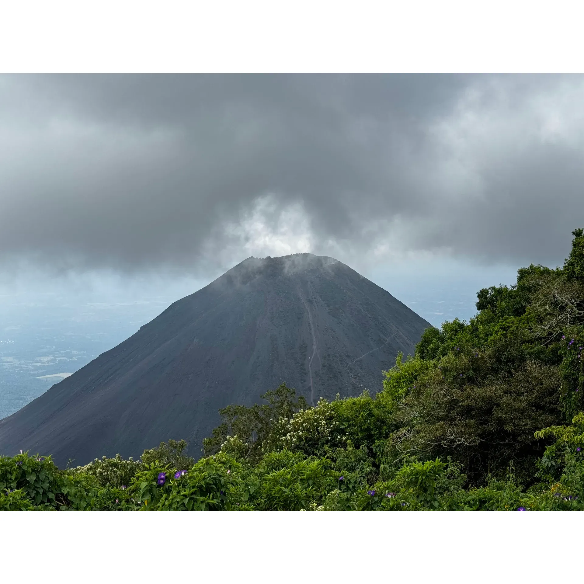 Parque Nacional Cerro Verde offers an exhilarating and memorable experience for adventure enthusiasts with its premier attraction—the hike up Santa Ana Volcano. With an affordable group tour that kicks off at 9:15 am for just $3 per person, you’ll be in the company of fellow hikers as you embark on a journey through breathtaking landscapes. For those seeking a more personalized adventure, a private tour is available for $35, allowing the freedom to start at any time and proceed at a comfortable pace.

Visitors to the park will appreciate the value-for-money entrance fee of $3, which grants access to a well-organized experience complete with a dedicated guide. Larger groups embark on the trail together, taking moments to gather valuable insights and instructions from their guide before proceeding. Along the route, which ascends to remarkable heights of 2,300 meters above sea level, there are designated stops including a check-in point to ensure safety and compliance.

For the enthusiastic hiker, the ascent of Santa Ana Volcano is a rewarding challenge. The 4km trail may take approximately 2.5 hours to summit and slightly less to descend, but the panoramic views and sense of accomplishment are well worth the effort. Adventurers are advised to come prepared with proper footwear, water, and appropriate attire for varying conditions.

While the hike is robust—and with over 4,000 steps, it's quite a workout—it's essential to assess your fitness level before undertaking the climb. However, even for those who choose not to trek, the park presents a delightful locale with stunning views, local shopping options, and welcoming eateries where visitors can relax and enjoy the natural beauty.

Accessing Parque Nacional Cerro Verde is hassle-free, whether via public bus, Uber, or private vehicles—with well-maintained roads leading to the destination. Parking is also extremely economical, with nominal fees for vehicles.

The park staff earns high praise for their kindness and readiness to assist, enhancing the overall visitor experience. The opportunity to climb an active volcano and peer into its crater presents a unique encounter with nature that's not only physically engaging but also immensely gratifying. Completing the round-trip in about five hours, guests leave with a sense of achievement and awe from the unmatched vistas and the vibrant energy of this natural Salvadoran treasure. Description by ChatGPT.