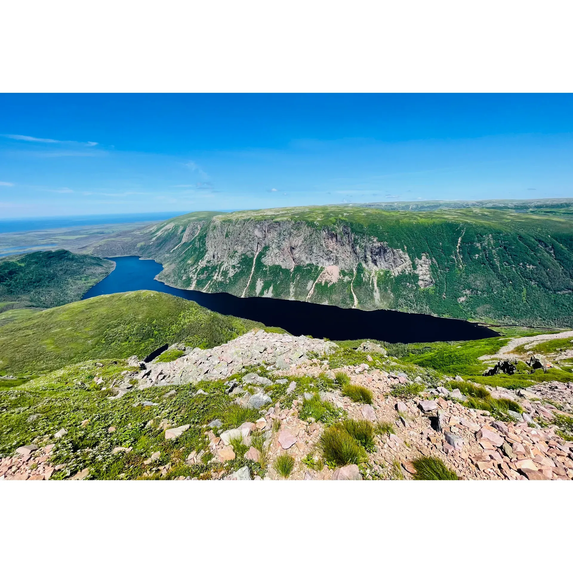 Venture into the heart of Gros Morne National Park and experience the exhilarating Gros Morne Mountain Hiking Trail, revered as one of the premier hiking adventures by enthusiasts. This prestigious trail attracts ambitious hikers seeking to immerclicks the allure of the wilderness with a challenging yet immensely rewarding ascent.

Embark on a journey that begins with a gentle amble alongside the river, where the tranquility of nature sets the pace for the initial 5 km stretch. As you progress, anticipate an engaging rise in elevation, culminating in a steep 1.5 km scramble over a gripping scree slope that demands resilience and determination. As the incline increases, so does the excitement, leading adventurers to conquer an impressive altitude of 806 meters.

Hikers equipped with sturdy footwear traverse narrow pathways that wind through the pristine landscape, with the windswept summit providing an astounding panoramic vista of the Long Range Mountains. Standing atop this natural marvel, the sensation of reaching the pinnacle is an unparalleled accomplishment. The peak experience is complimented by the opportunity to capture this majesty in photographs or to simply revel in the expansive views, cocooned in one of the rock shelters designed to shield visitors from the brisk mountain breezes.

The descent offers its own array of visual wonders, including a mesmerizing glimpse of the lake far below. Every step downward is filled with the grandeur of the valley's landscape, balancing the rugged descent with awe-inspiring scenery.

Seasoned hikers and those in sound physical condition find their efforts amply rewarded, with the full journey spanning approximately 7 to 8 hours. This allows ample time to immerse oneself in the natural splendor, partake in brief reposes, and savor snacks and hydration to maintain energy levels throughout the day.

Intrepid explorers may also discover additional elements of adventure, such as the option to embrace an overnight stay in the mountainside tent and hut areas, enhancing the wilderness experience.

Commended for its breath-stealing beauty and invigorating trek, the Gros Morne Mountain Hiking Trail stands as a testament to those seeking to elevate their hiking repertoire. While it is a treasure cherished by seasoned hikers, it also invites all who are adequately prepared to venture forth and witness the spectacle of Gros Morne's rugged magnificence. Description by ChatGPT.