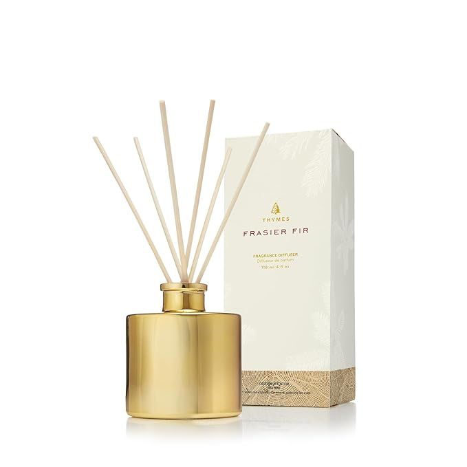 Thymes Petite Gold Frasier Fir Diffuser is a home fragrance diffuser set that includes reed diffuser sticks, fragrance oil, and a glass bottle oil diffuser. The fragrant oil is infused with the fresh, forest scent of Frasier fir, creating a cozy and inviting atmosphere in any room.