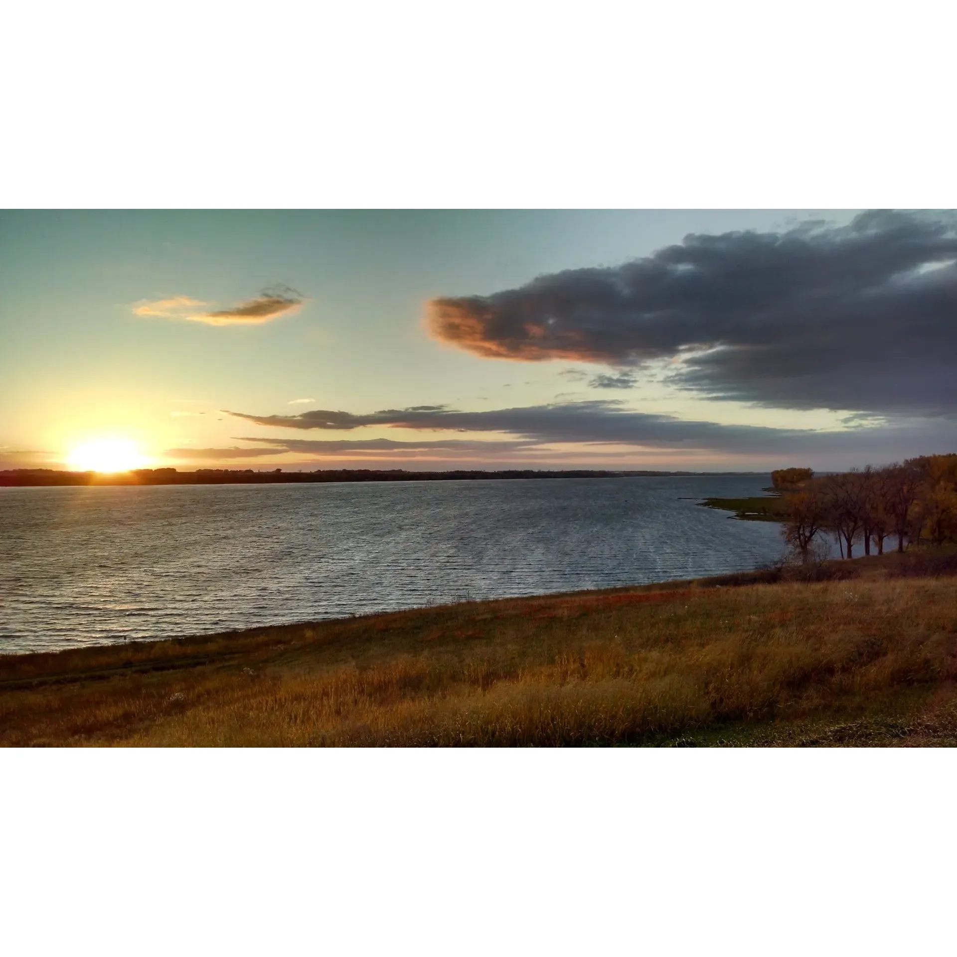 Lac qui Parle State Park stands out as a scenic destination boasting expansive beauty along the shorelines of Lake Lac Qui Parle. The park captivates with its exceptionally clean and modern upper campground, providing visitors with an environment that accentuates hygiene and orderliness. Picturesque walking trails are meticulously maintained, offering serene ambience for strollers and nature lovers to enjoy the park's natural splendors.

Visitors to Lac qui Parle State Park are treated to breath-taking vistas from atop the park's magnificent bluffs, creating an unforgettable experience for all who venture there. The presence of the state's record-holding cottonwood tree adds to the park's allure, providing a unique and memorable highlight that is easily accessible and sought after by nature enthusiasts.

Anglers, hunters, and those simply seeking tranquility will find an abundance of spots perfect for their recreational pursuits, be it on the water or amidst the lush surroundings. With an emphasis on the relaxation and recreation that nature offers, the park catulates an atmosphere of escapism from the hustle and bustle of daily life.

The upper campground is particularly admirable, praised for its picturesque views and the comfort of having clean, well-appointed shower and bathroom facilities. This elevated part of the park has been thoughtfully furnished with both full hookup sites for RV enthusiasts and scenic lake views, ensuring that each visitor can find their preferred way to unwind.

Historical structures, including a 19th-century mission and buildings created by the Works Progress Administration, stand as testaments to the park's rich cultural tapestry. For water enthusiasts, paddling and boating opportunities abound, inviting guests to explore the lake's vast and tranquil waters.

Highly regarded for its wide-open prairie land, the park's upper campground features spacious and open sites that allow for a breezy, sunlit camping experience. The friendly and accommodating park staff enhance the guest experience, providing a warm and inviting atmosphere.

The beach area, with its mix of small gravel and large shoreline rocks, presents a unique and photogenic landscape for visitors. Though more rugged than a conventional sandy beach, it is precisely this rustic charm that contributes to the park's picturesque character.

In sum, Lac qui Parle State Park offers an enchanting retreat rich in natural beauty and recreational variety, complemented by impeccable facilities and heartwarming hospitality that together promise a serene and fulfilling outdoor experience. Description by ChatGPT.