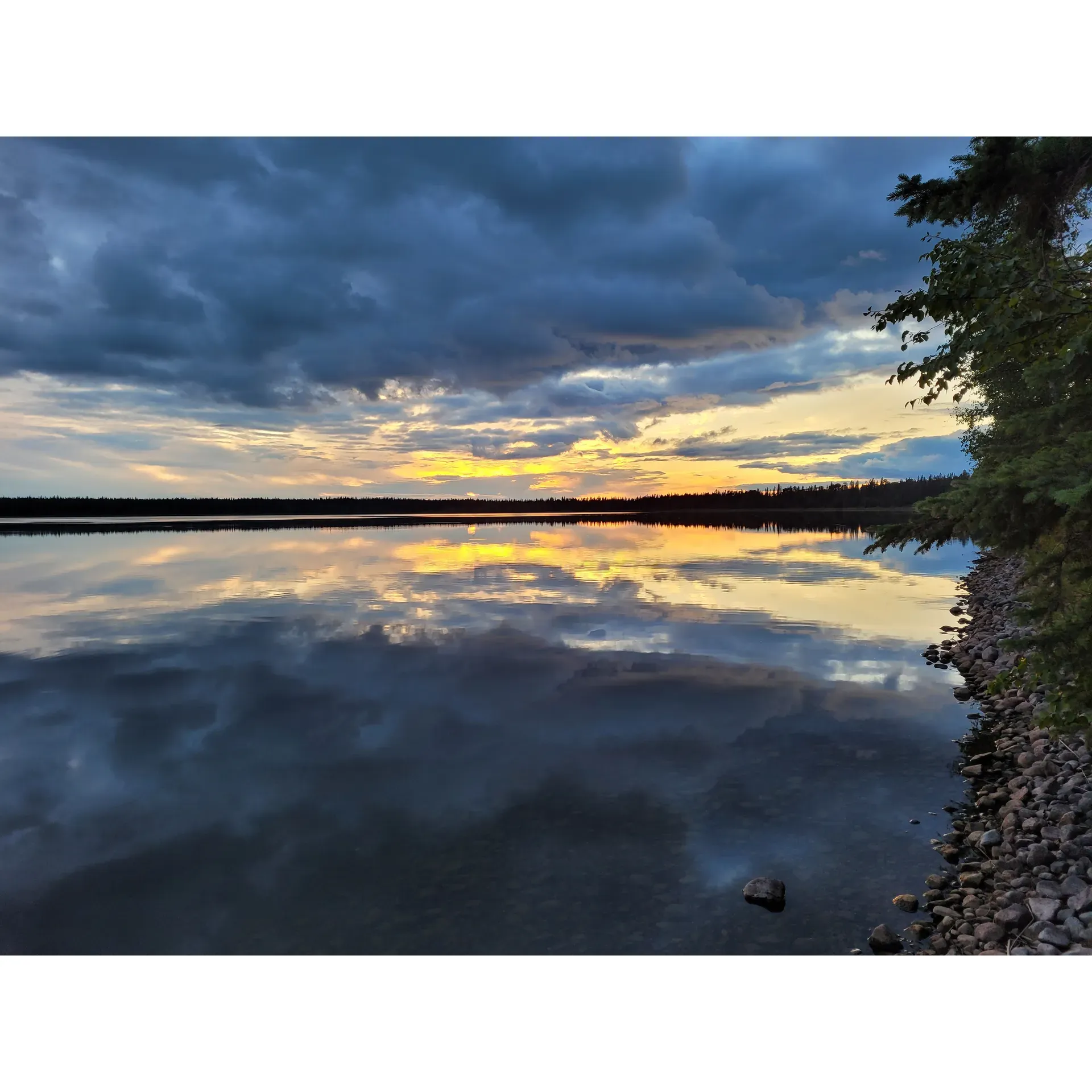 Lily Lake Campground offers an idyllic outdoor experience for campers seeking a serene escape in the heart of nature. With two exclusive canoe-in campsites, guests are assured of a private retreat away from the bustling crowds, allowing them to connect with nature's tranquility. The campsites are beautifully maintained, ensuring that each visitor can immerse themselves entirely in the peaceful surroundings.

The adventure begins with a paddle across the scenic Lily Lake, where the clear waters serve as a gateway to your secluded camping haven. Upon arrival, campers are greeted by the rustic charm of the wilderness, with ample opportunities to engage in traditional camping activities. Each site provides plenty of space, inviting guests to set up their tents and create a cozy home base amidst the whispering trees.

As an added convenience, the campground encourages guests to channel their inner woodsmen by bringing along an axe to chop wood for their campfire needs. The tactile experience of preparing firewood adds to the immersive outdoor atmosphere, with the reward of crackling fires under the starry night sky.

Catering to the essential comforts, visitors will appreciate the meticulously maintained outhouse facilities. The cleanliness and regular stocking of necessities, including toilet paper, reflect the campground’s commitment to ensuring a comfortable and worry-free experience for all its guests.

Anglers will be delighted by the bountiful Jackfish population that calls Lily Lake home. Whether you’re a seasoned fisherman or trying your hand at the sport for the first time, the lake provides an excellent opportunity for a successful day of fishing amidst stunning natural scenery.

Lily Lake Campground is truly a gem for those looking to escape the ordinary and enjoy a tranquil outdoor adventure surrounded by wildlife, water, and whispering pines. Description by ChatGPT.