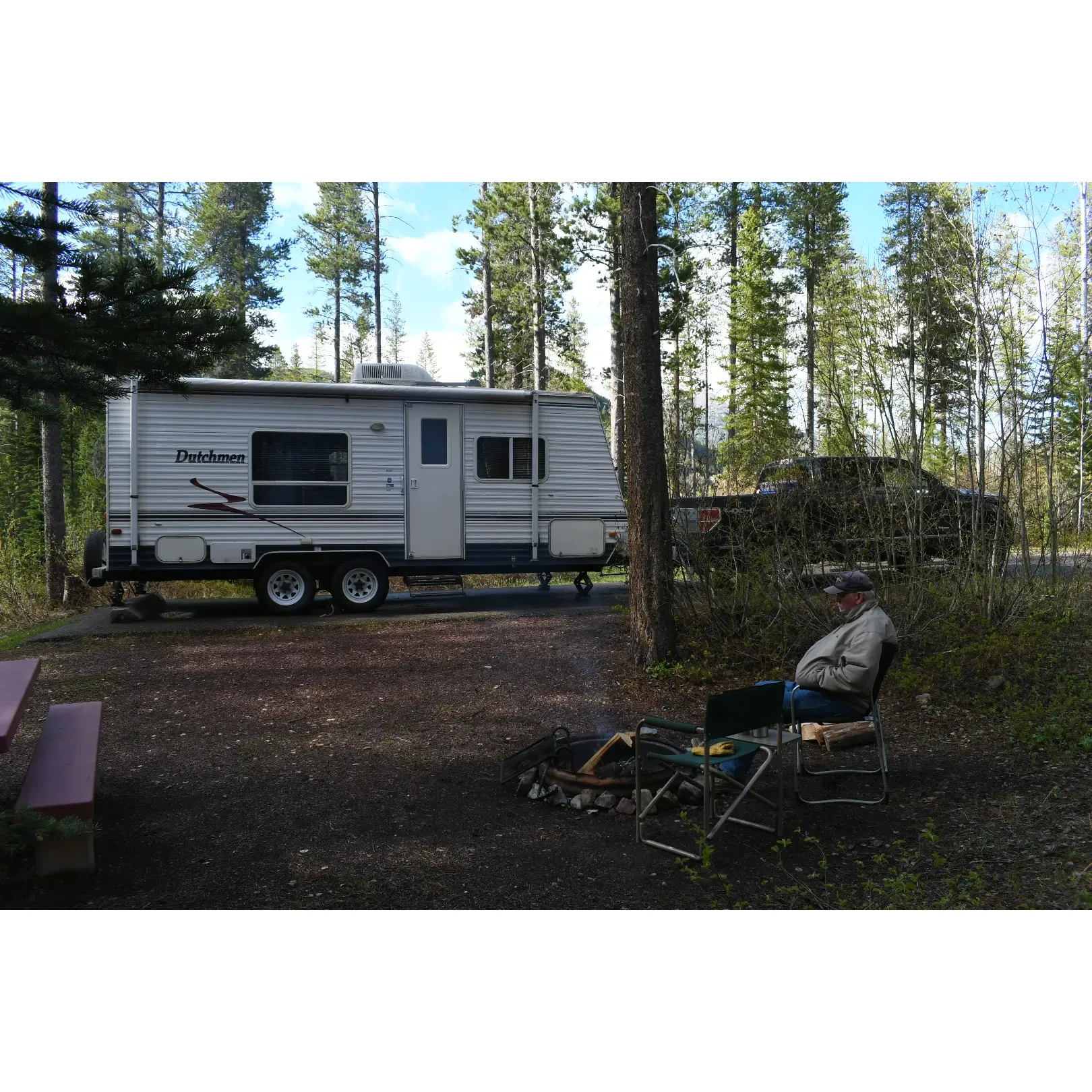 Devil Creek Campground offers an inspiring retreat for outdoor enthusiasts looking to immerse themselves in the splendor of Montana's rugged landscapes. With its strategic location, the campground presents the ultimate convenience for adventurers eager to explore the diverse offerings of Glacier National Park. Situated just 35 minutes from West Glacier and an hour from the east entrance, it serves as the perfect basecamp for those aiming to cover expansive ground within the park.

The campgrounds boast spacious and roomy sites, providing a serene setting with beautiful views of the surrounding wilderness. The area is a haven for those seeking picturesque vistas and awe-inspiring night skies, free from the interference of artificial lighting—though visitors are encouraged to pack a flashlight for nocturnal ventures.

Devoted camp hosts, Randy and Karen, bring warmth and diligent care to the campground experience, zipping around in their charming golf scooter to ensure everything runs smoothly. Their attention to detail is evident, with guests regularly highlighting the impeccably maintained amenities. To the delight of visitors, the restrooms at Devil Creek Campground are praised for their exceptional cleanliness—a rare find in the midst of nature.

For the soothing sounds of nature, select campsites sit adjacent to a roaring little creek, adding to the ambiance of the wilderness setting. While facilities are continually improving, with potable water expected to be available in following seasons, the campground maintains its rustic charm.

Given the campground's proximity to natural elements, weather at Devil Creek can indeed be unpredictable, with frosty nights even in summer months. However, this merely adds to the authentic camping experience as guests gather to share stories under the starlit sky. The campground's locale does include proximity to a highway and major rail route, yet many find that the convenience of access and the hosts' exceptional service far outweigh this aspect of the experience.

Devil Creek Campground is a highly recommended destination for those desiring a tidy, accessible, and well-kept launchpad for their wilderness expeditions. Karen and Randy continue to receive accolades for their outstanding hospitality, making every camper's stay memorable. With stunning natural beauty and top-tier campground management, Devil Creek stands out as an idyllic spot for both relaxation and adventure in Big Sky Country. Description by ChatGPT.