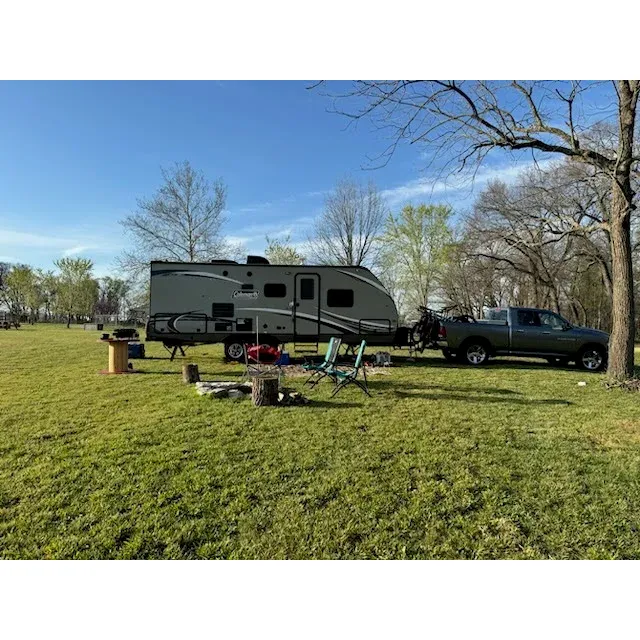 Pea Ridge Bike Camp is a picturesque outdoor retreat that offers campers a harmonious blend of natural splendor and thoughtful amenities. With hosts who are dedicated to creating a warm and welcoming environment, visitors instantly feel a sense of belonging and ease. The spacious, flat sites are meticulously maintained, ensuring not only beauty but also functionality for all guests. Adorned with fire pits and unique spool tables, each site promotes a cozy and inviting atmosphere ideal for relaxation or social gatherings.

The camp is pet-friendly and has been thoughtfully outfitted with sizeable ADA-accessible porta-potties, further emphasizing the hosts' commitment to comfort and inclusivity. Bike enthusiasts will appreciate the convenient bike wash station, making it easy to clean up after a day of exploring the trails. For a more communal experience, there is also a central fire pit where guests can mingle and share stories under the stars.

Damon, the on-site host, is renowned for his friendliness and eagerness to enhance each camper's experience. An avid history buff and conversationalist, he enhances the camping adventure with engaging tales and helpful insights into the area. Whether it's ensuring your safety during inclement weather by offering shelter or merely being a friendly face, Damon goes above and beyond to serve his guests.

Located near Bentonville, the campsite offers a secluded haven on private land with easy access to nature's beauty, including breathtaking sunrises and sunsets over an open field. The facilities include well-kept outhouses and a shower with warm water, which is cleaned daily, ensuring a comfortable and refreshing stay. With ten sites complete with fire pits, guests can embrace the great outdoors while still enjoying modern conveniences.

The hosts, Damon and Robin, consistently exceed expectations, readily providing all the necessities and more to guarantee a memorable stay. Whether you're setting up a truck bed tent or pitching a traditional tent, Pea Ridge Bike Camp delivers an exceptional camping experience that beckons visitors to return time and again. This delightful campsite is not just a place to stay—it's a destination where adventure and hospitality meet. Description by ChatGPT.