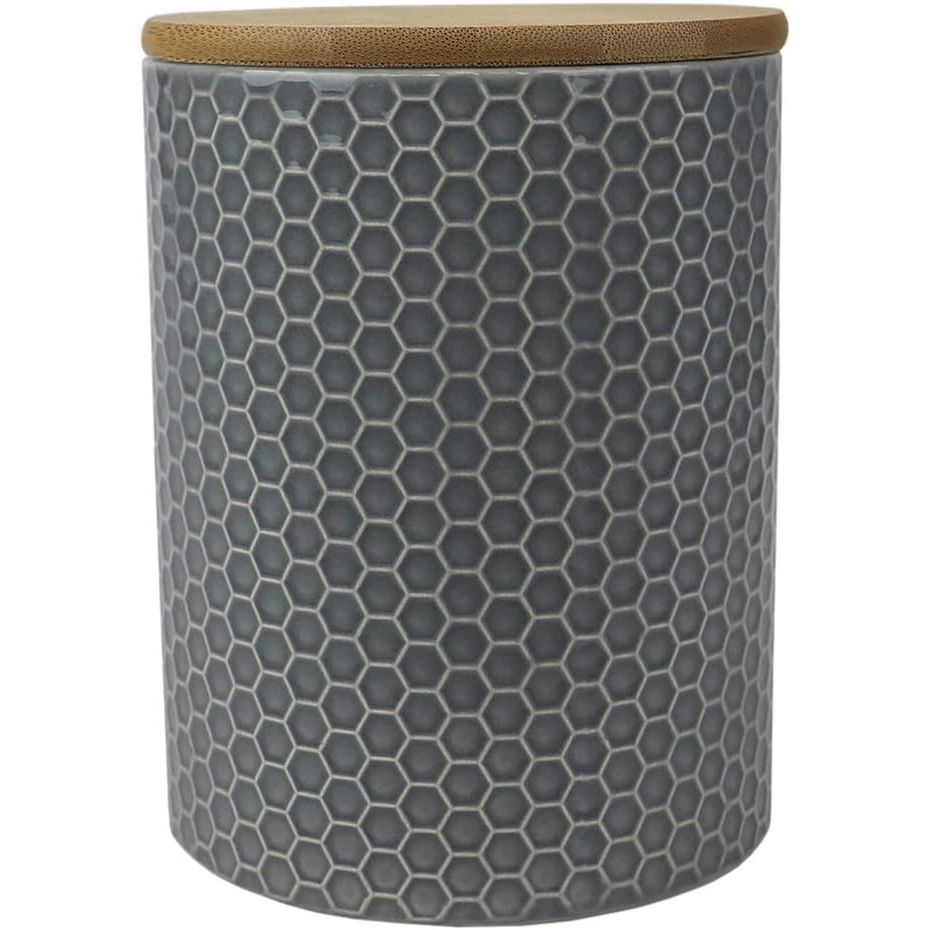 The Home Basics Honeycomb Medium Ceramic Canister in Grey is the perfect blend of style and functionality for your kitchen or pantry. Crafted from durable ceramic material, this canister is built to withstand the test of time while maintaining its strength and sturdiness.