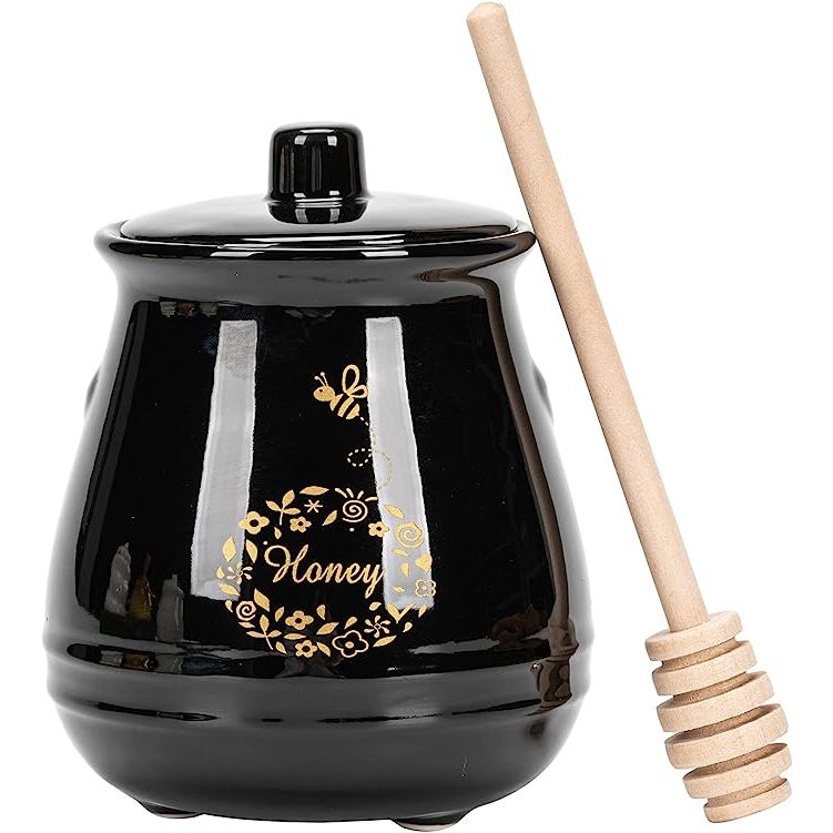 Enhance your home kitchen with the sleek and sophisticated KEKEHOME Ceramic Honey Pot with Lid and Wooden Dipper. Crafted from black porcelain, this stylish honey jar adds a touch of elegance to any countertop or pantry.