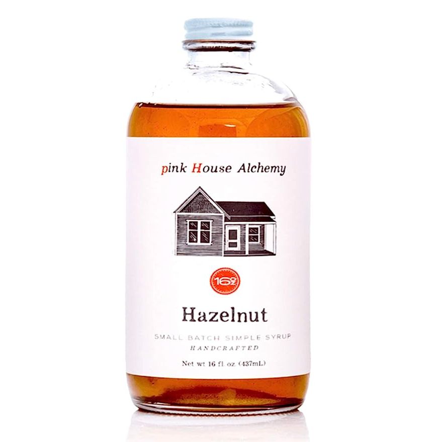 Introducing Pink House Alchemy's Hazelnut Simple Syrup, a 16 oz bottle of pure goodness crafted with all-natural, non-GMO ingredients. Experience the delightful taste of real hazelnuts infused into this exquisite syrup, ideal for elevating the flavor of your coffee, cocktails, and non-alcoholic mocktails.