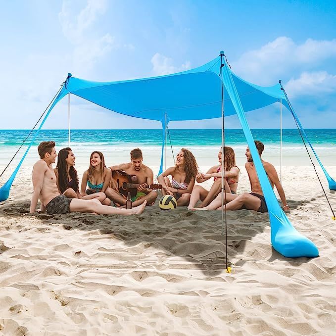 Experience the ultimate shelter on your beach outings with the Aluminum Large Family Pop Up Beach Tent by COMMOUDS. This spacious tent measures 7 x 7 ft and features 4 aluminum poles that reach an impressive height of 5.8ft, providing ample shade for 4-5 people.