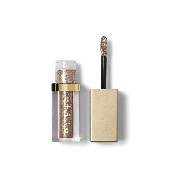 Elevate your eye makeup game with the show-stopping radiance of Stila's Magnificent Metals Glitter And Glow Liquid Eye Shadow. Renowned for its stunning sparkle and advanced formula, this cult-favorite product promises to deliver a glittering effect that lasts all day or night.