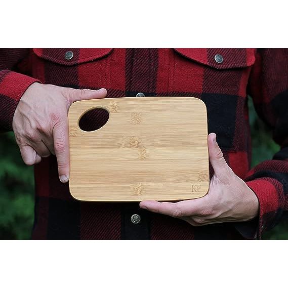 Looking for a must-have tool for outdoor enthusiasts? Look no further than our small bamboo cutting board! Whether you're camping, backpacking, hiking, or engaging in any outdoor activity, this versatile and portable cutting board is a game-changer. Made from sustainable and fast-growing bamboo, it offers excellent durability, strength, and an attr