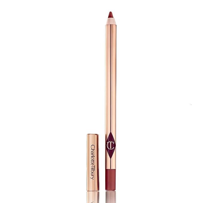 Unleash the striking beauty of luscious, defined lips with Charlotte Tilbury's Lip Cheat in the iconic Walk of Shame hue—a must-have staple in the beauty arsenals of discerning makeup connoisseurs. This exquisitely versatile lip liner, the brainchild of the illustrious makeup artist Charlotte Tilbury, demonstrates unwavering excellence in both quality and flexibility, ensuring your pout stands out with every smile.

Indulge in the ravishing charm of Walk of Shame, the quintessential medium berry shade enriched with an infusion of rosy undertones—an elegant color choice that masterfully harmonizes with an extensive array of skin tones. Engineered to simulate a naturally voluptuous look, Lip Cheat is your secret weapon for sculpting impeccable lip contours, enhancing fullness, and imparting a captivating, natural blush to your lips.

Crafted for perfection, Charlotte Tilbury's Lip Cheat in Walk of Shame boasts a luxuriously creamy composition that surrenders to your lips with an impeccable ease of application. Richly pigmented for a dazzling impact, this lip liner promises a striking color payoff that endures, setting the stage for either a bold statement-making look or a graceful lipstick base. Its exceptional longevity stands staunch against smudging and feathering, keeping your pout pristine from dawn to dusk. Beyond its impressive color and textural allure, it offers hydrating benefits, ensuring that your lips remain supple and pampered. Versatility is at the heart of the Lip Cheat experience, allowing you to deploy Walk of Shame as both a precise lip-definer and an all-over color—a seamless blend that effortlessly navigates between subtle elegance and defined chic. For beauty aficionados eager to amplify their lip game, Charlotte Tilbury's Lip Cheat in Walk of Shame is an indispensable treasure, delivering sophisticated color, enduring wear, and a velvety-smooth finish to craft the perfect pout.