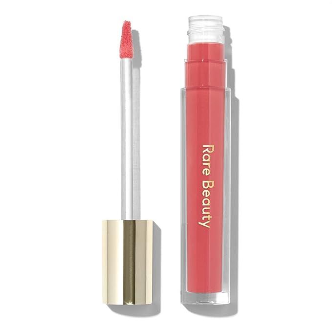 Introducing the Stay Vulnerable Glossy Lip Balm in Nearly Apricot from Selena Gomez's Rare Beauty – the ultimate hybrid in lip care that's been making waves in the beauty community. Unleash the power of a lip balm's nourishing comfort coupled with the allure of a high-shine gloss, all embodied in a singular shade that magnifies your natural charm.