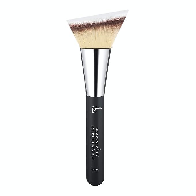 Experience the perfection of foundation application with the IT Cosmetics Heavenly Luxe Bye Bye Foundation Brush #22, your ultimate tool for creating a flawless complexion. This innovative brush boasts a distinctive triangle-shaped head that masterfully blends your foundation, ensuring a seamless and authentically natural finish with every stroke.