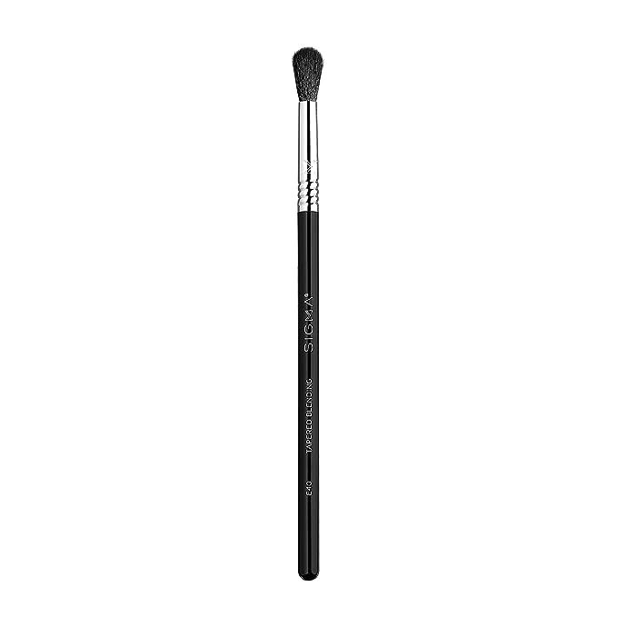 Sigma Beauty Professional E40 Tapered Blending Eye Makeup Brush with SigmaTech fibers is a high-quality blending eyeshadow brush used by professional makeup artists and beauty enthusiasts alike. This brush is designed to effortlessly and seamlessly blend eyeshadow colors together, creating a flawless and professionally executed eye makeup look.