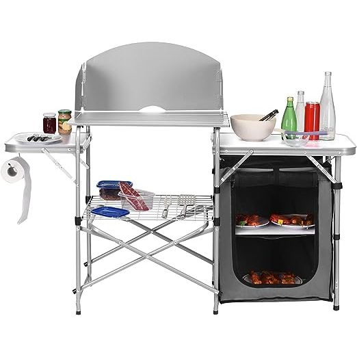 The Goplus Folding Grill Table with Storage is a versatile and compact outdoor kitchen table designed for camping, BBQs, picnics, and backyard gatherings. Made from durable aluminum, this table features a 26-inch tabletop that provides ample space for food preparation and cooking.