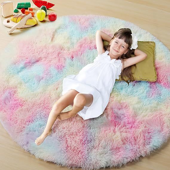 Introducing the Super Soft Furry Rug, a must-have for any girl's room decor. Crafted with upgraded plush fibers and a thicker backing, this rug offers a luxurious and comfortable feel for your feet. Perfect for kids' rooms and play areas, it creates a cozy and warm ambiance that your little ones will love.