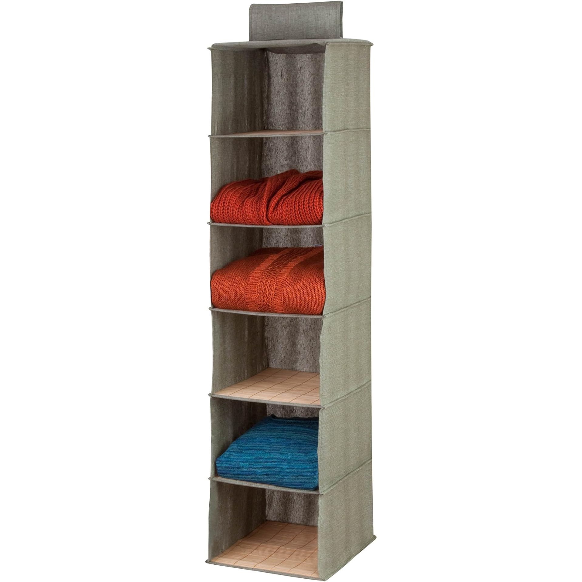 Introducing our Bamboo and Canvas Hanging Closet Organizer, a practical and eco-friendly solution for decluttering your closet space. This organizer is crafted from natural bamboo and canvas material, ensuring durability and a chic aesthetic. With its unique design, it saves valuable floor space by allowing you to hang your clothes off the ground.