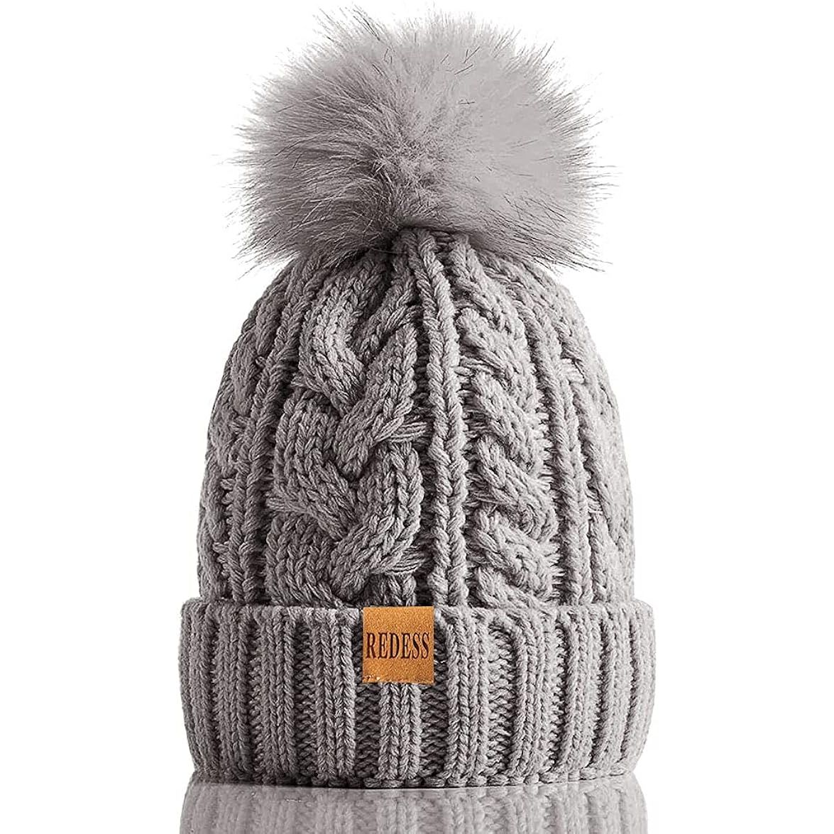 The REDESS Women Winter Pompom Beanie Hat with Warm Fleece Lined is a stylish and practical accessory designed to keep women warm during the cold winter months. This hat features a thick slouchy snow knit skull design that adds a trendy and relaxed touch to any outfit.