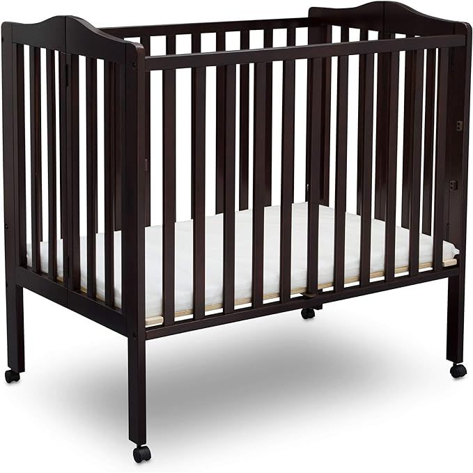 The Delta Children Folding Portable Mini Baby Crib is a convenient and versatile crib option for parents looking for a portable sleeping solution for their little ones. It is designed with a folding mechanism, allowing easy storage and transportation. The crib comes in a Dark Chocolate finish, giving it an elegant and contemporary look.