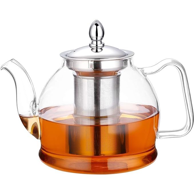 Introducing our beautifully handcrafted teapot made from heat resistant borosilicate glass. This teapot is not only aesthetically pleasing but also designed with functionality in mind. It features a non-dripping spout and an ergonomic handle for a sturdy grip.