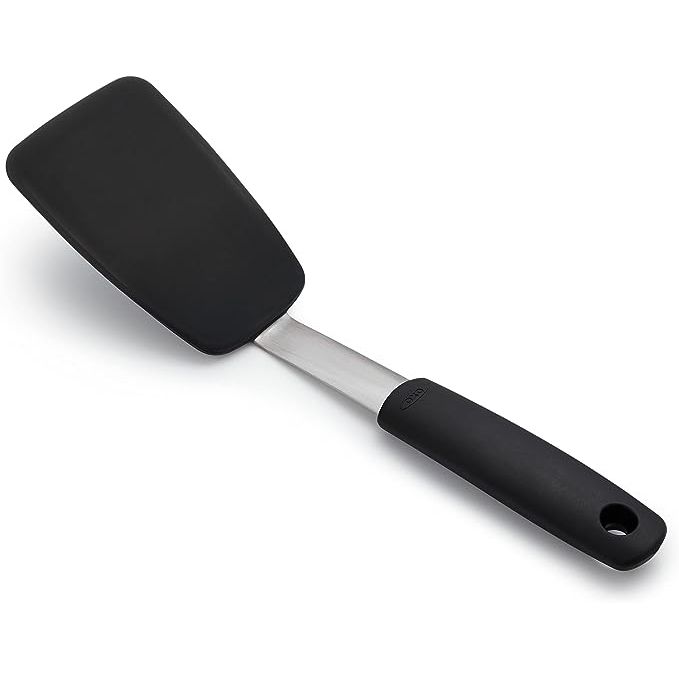 The OXO Good Grips Small Silicone Flexible Turner in black is a must-have tool for any kitchen, offering easy flipping and lifting of delicate foods like eggs, pancakes, and fish.