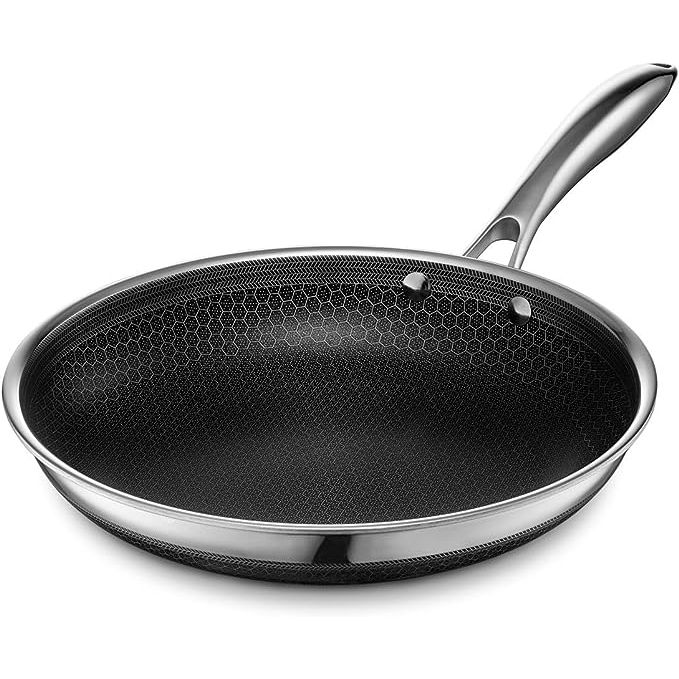 Experience the ultimate in cooking performance with the HexClad Hybrid Nonstick Frying Pan. Boasting a unique hexagonal patterned surface that combines stainless steel and nonstick technology, this 10-inch pan offers durability and versatility.