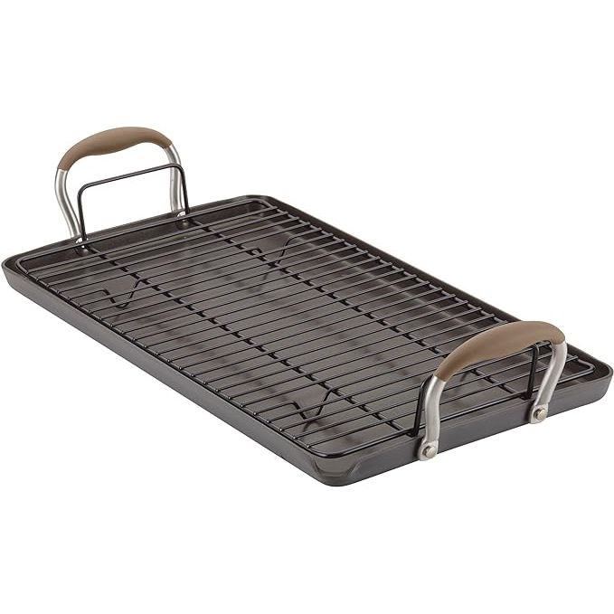 Enhance your cooking experience with the Anolon Advanced Home Double Burner Griddle/Grill Pan with Roasting Rack. This multifunctional 10 inch x 18 inch pan is crafted from hard-anodized aluminum for durability and even heating. The nonstick interior ensures effortless food release and cleanup, making cooking a breeze.