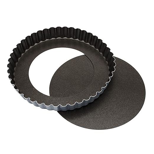 Experience the professional quality of the Matfer Bourgeat Exopan Fluted Tart and Quiche Pan, crafted from durable dark gray steel for optimal heat distribution and consistent baking results. The unique fluted edge design adds a touch of elegance to your creations, while the removable bottom allows for effortless serving.