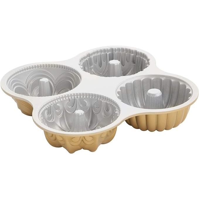 The Nordic Ware 91377 Nordicware 9 Cup Bundt Quartet Pan is a versatile and durable baking pan crafted from heavy-duty cast aluminum. This innovative pan features four distinctive bundt cake designs in one, allowing you to effortlessly create stunning cakes for any occasion.