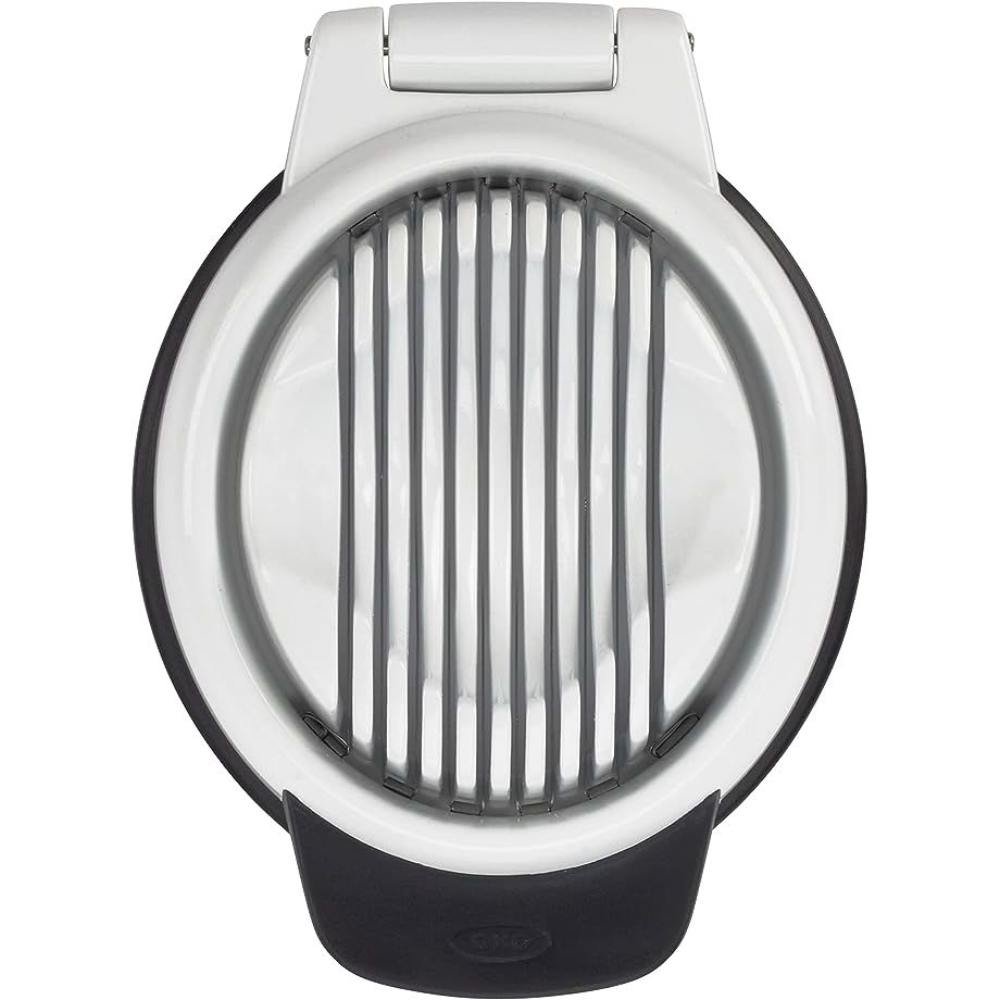 Make meal prep a breeze with the OXO Good Grips Egg Slicer! This versatile kitchen tool boasts a durable plastic body and stainless steel wires for precise slicing of hard-boiled eggs. Its compact and ergonomic design ensures ease of use and storage, while the non-slip base keeps it steady during slicing.