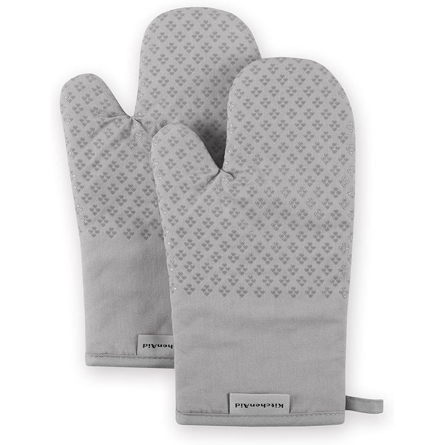 Introducing the KitchenAid Asteroid Oven Mitt Set, a must-have addition to your kitchen collection. This 2-piece set comes in a stylish grey color that will effortlessly blend in with any kitchen decor. Measuring at 7x12.