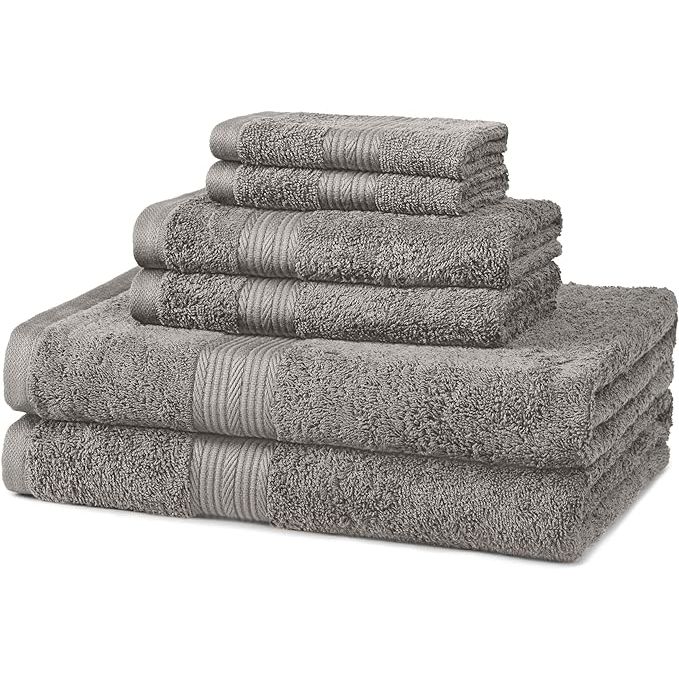 The Amazon Basics 6 piece Fade Resistant Oversize Bath Towel, Hand and Washcloth Set is made from 100% cotton material, ensuring softness and absorbency. The set comes with two bath towels, two hand towels, and two washcloths, providing bath essentials for everyday use.