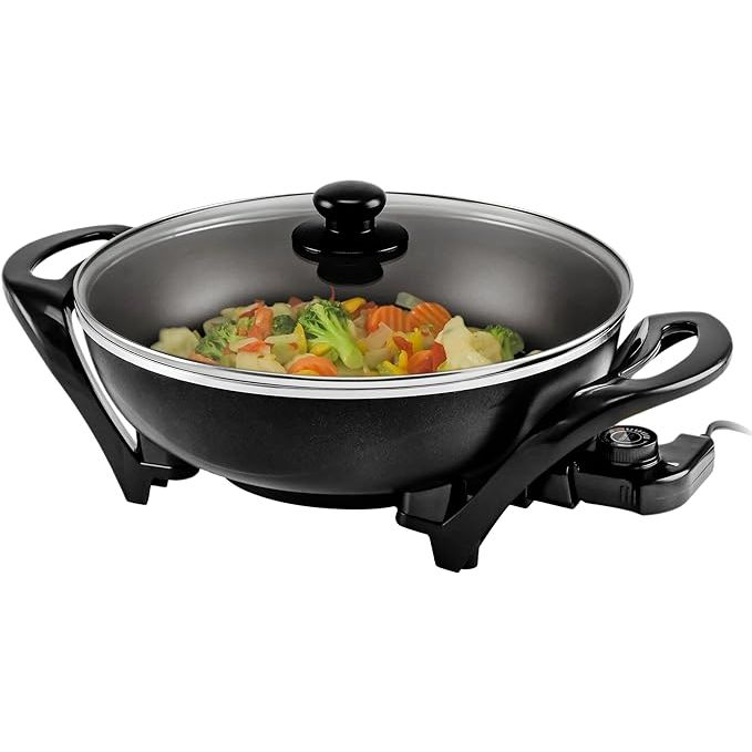 Experience the culinary versatility and convenience of the OVENTE Electric Wok, a 13-inch family-sized wonder that transforms the way you cook. Boasting a durable nonstick coating, this skillet is specially designed for effortless cooking and quick cleanup, ensuring your meals turn out perfectly every time with minimal effort.