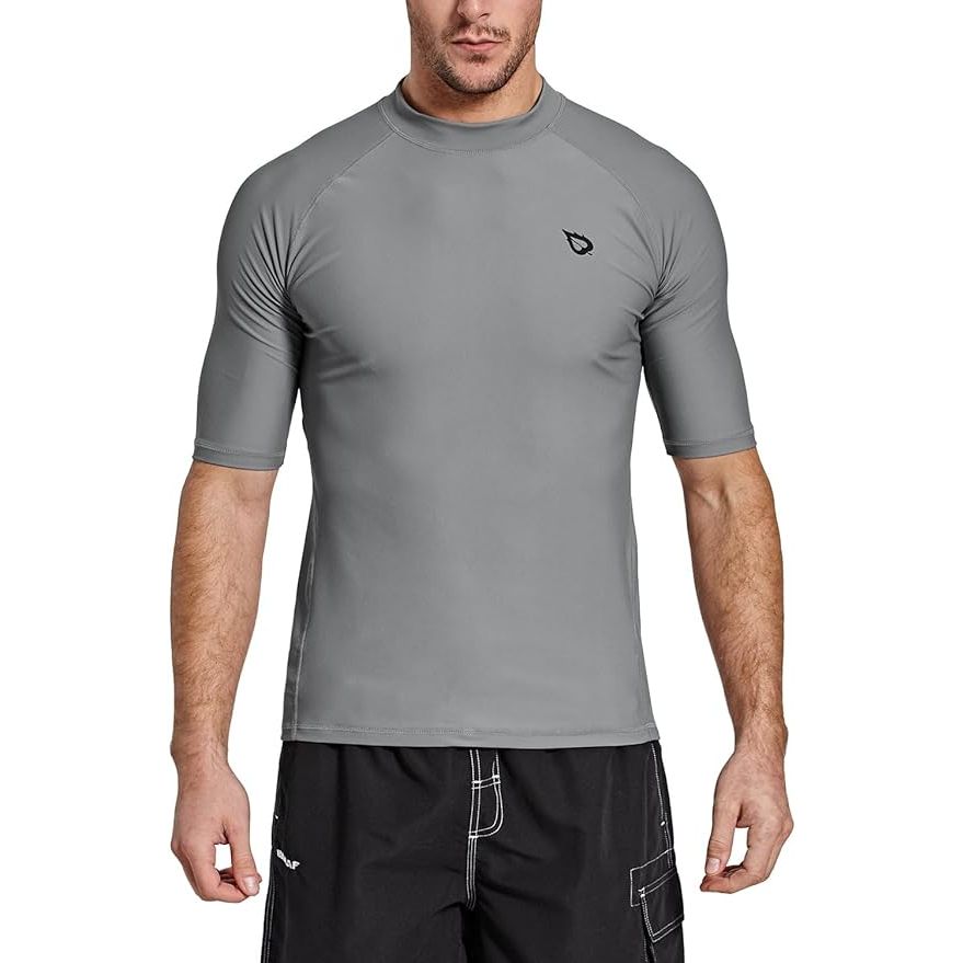 The BALEAF Men's Rash Guard Short Sleeve Swim Shirt is designed for active water sports enthusiasts seeking protection from the sun's harmful rays. Made with UPF 50+ sun protection fabric, this shirt blocks 98% of the sun's harmful rays, keeping your skin safe during prolonged exposure to the sun.