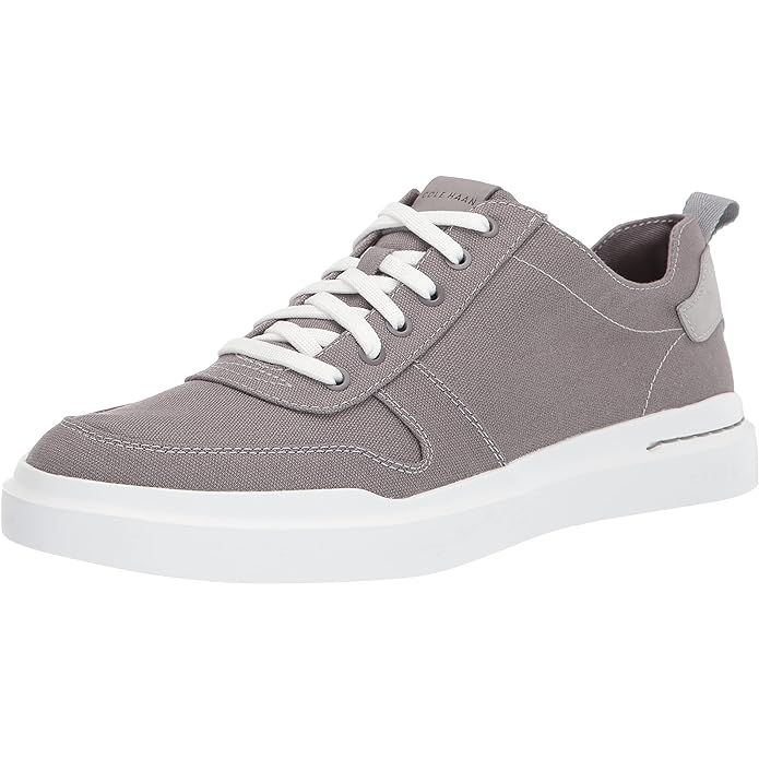 Cole Haan's men's Grandpro Rally Canvas Court Sneaker offers a stylish and comfortable footwear option for everyday wear. The sleek design of these sneakers features a canvas upper with leather accents, adding a touch of sophistication to their sporty look.