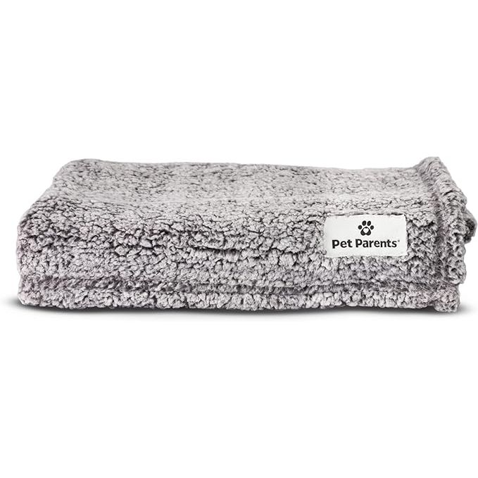 The Pet Parents Pet Blanket is a water-resistant blanket designed for cats and dogs of all sizes. Measuring at 24"x32", this blanket is perfect for small, medium, and large dogs. It is also suitable for use on couches, beds, or car seats to protect them from dirt, hair, and accidents.