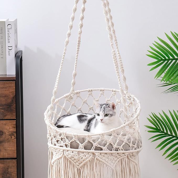 The Boho macrame cat hammock bed is a sturdy and durable option for your feline friend. Made of 100% natural high-quality cotton rope, this hammock features a stable double steel hoop base and thick, soft rope that is perfect for cats who like to curl up.