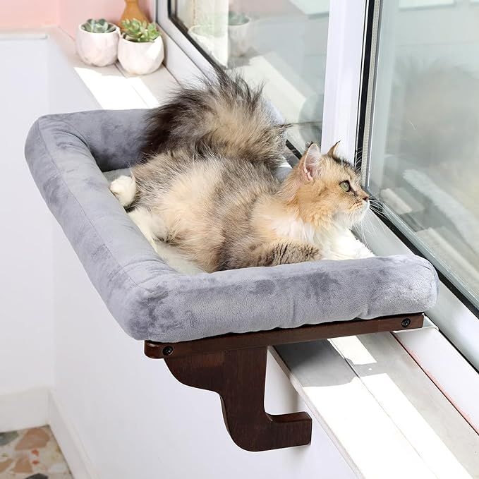 The Zakkart Cat Perch for Window Sill with Bolster is a sturdy and stylish cat window seat designed to provide a comfortable resting spot for large cats and kittens. The orthopedic hammock design offers support for your pet's joints and muscles while they lounge in the sun and watch the world go by outside.