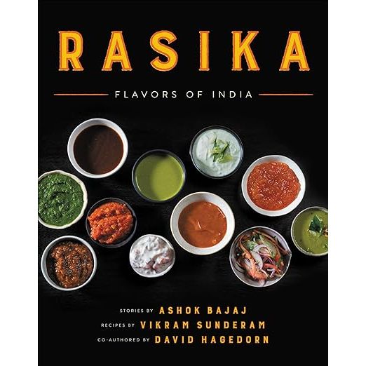 Embark on a gastronomic journey with Rasika: Flavors of India, the quintessential guide to redefining Indian cuisine, penned by culinary connoisseurs David Hagedorn, Ashok Bajaj, and Vikram Sunderam. This exquisite cookbook is your personal escort into the kitchens of the renowned Rasika restaurant in Washington D.C., a name that resonates with the epitome of Indian culinary innovation and authenticity. Praised by gourmets and critics alike, Rasika's delightful array of dishes has positioned it at the forefront of the global culinary map, making this compilation a must-have for every epicurean enthusiast.

Delve into a world where traditional Indian culinary artistry meets contemporary finesse. Rasika: Flavors of India meticulously curates a trove of recipes that will enchant your taste buds, marrying the beloved classics with avant-garde interpretations. Savor the lustre of butter chicken, the rich heritage wrapped in layers of aromatic biryani, and step into a tide of modernity with avant-garde creations such as the luscious avocado chaat and the spirited tamarind-margarita. This cookbook is a stirring ode to the myriad tastes of India, designed to transport the splendor of Rasika's table to yours.

A testament to beauty and clarity, the cookbook is adorned with striking photography and peppered with clear, approachable instructions, making the art of Indian cooking accessible to all. Rasika: Flavors of India is more than a cookbook—it's an invitation to infuse your culinary escapades with the zest and zeal of Indian cuisine. Whether you're just starting to explore the rich tapestry of Indian flavors or you're an adept chef seeking to infuse your creations with a dash of innovation, this collection promises a culinary voyage that will leave you inspired and your palate yearning for more. Discover the secrets behind Rasika's acclaim and let your culinary journey begin.