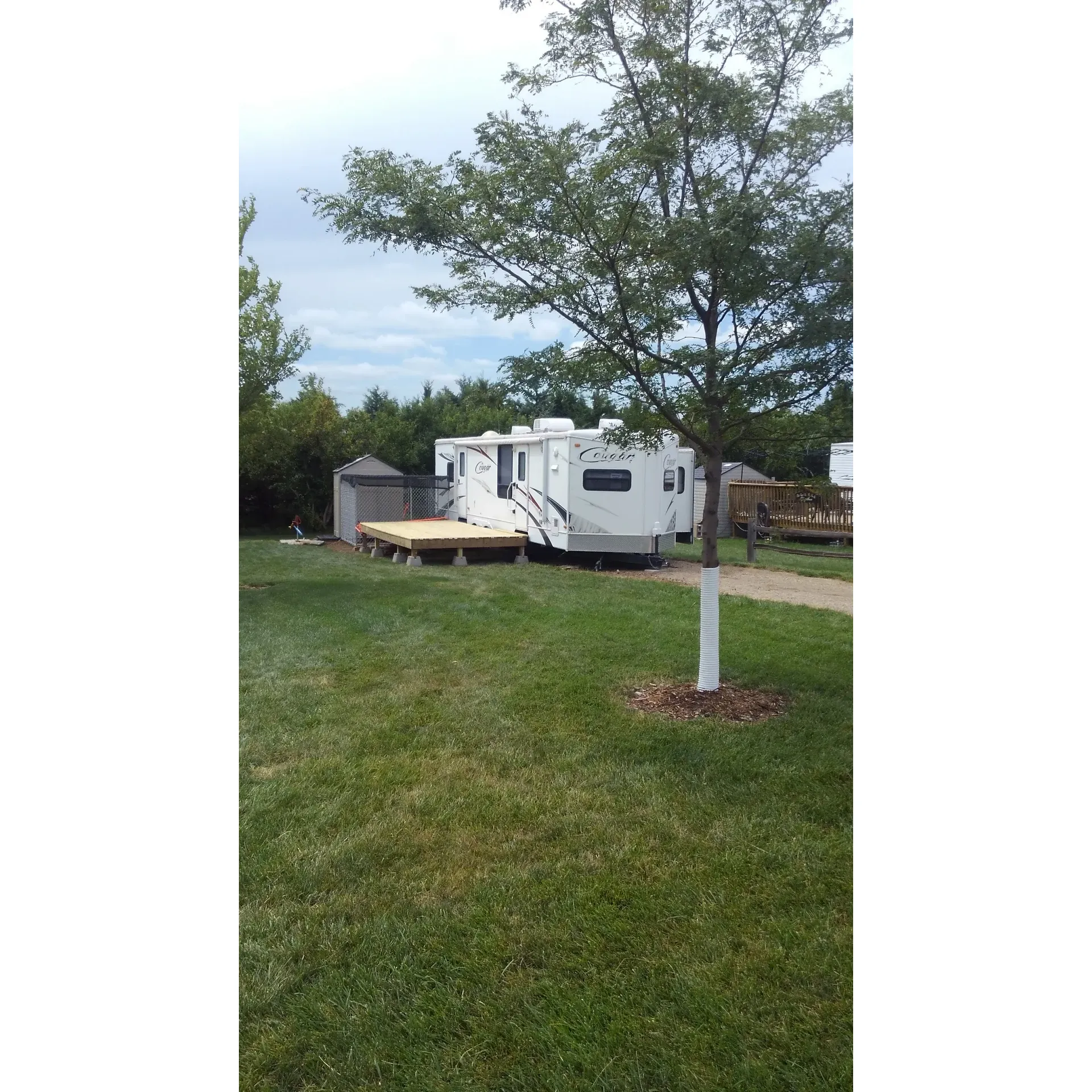 Five Mile Campground offers the serenity and beauty of the great outdoors combined with the comfort and community spirit of a well-kept retreat. Established in 2017, this spacious campground presents an orderly and clean environment for both short stays and yearly leased sites, catering especially to those seeking a seasonal haven for outdoor living. The lots are generously sized to give each visitor their own slice of tranquility, complemented by the simple, crisp beauty of youthful trees that promise lush greenery and shade in the years to come.

The grounds are exceptionally maintained, boasting pristine water for both utility and recreation which adds to the allure of a rustic yet comfortable camping experience. Facilities include convenient firewood provisions, ensuring that campers can enjoy the timeless pleasure of a crackling fire under the stars. Additionally, on-site dumpsters and optional garage rentals contribute to the ease of maintaining an organized and enjoyable campsite.

The camp's community spirit shines through the kindness and respect demonstrated by both the hosts and fellow campers. Visitors often remark on the friendly atmosphere and the ease with which one can form lasting friendships within this dog-friendly enclave. The spirit of camaraderie runs deep, as knowing one neighbor often leads to connections with many, creating a network of good company and shared experiences.

Positioned just 5 miles from the river, the campground provides a quiet respite still conveniently close to water-based activities without the congestion of river-adjacent sites. For those looking to unwind with family and friends, Five Mile Campground offers a peaceful and cordial environment where memories are made and cherished. While the amenities focus on the natural and communal aspects of camping life, there are also two tornado shelters provided for guest safety, ensuring peace of mind during outdoor adventures.

The absence of a general store, Wi-Fi, ATVs, and organized activities underscores the campground's commitment to a genuine, nature-centric escape, while lovely grounds and warm-hearted neighbors come together to fashion a delightful home-away-from-home—for a season or even longer. Five Mile Campground is an idyllic destination where great neighbors and thoughtful amenities converge to create a camping experience that is both harmonious and joyful. Description by ChatGPT.