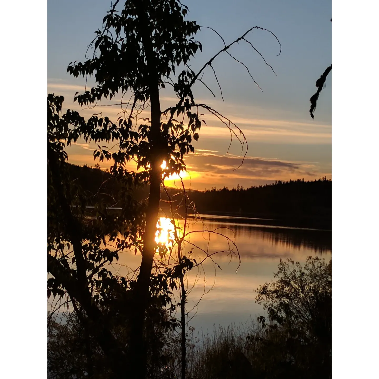 Rainbow Lake Campground is a serene outdoor retreat that offers a picturesque setting for camping enthusiasts and nature lovers alike. This idyllic destination is a favorite among those seeking a peaceful escape, with ample space ensuring a sense of privacy and tranquility throughout your stay.

The campground is recognized for its effective patrolling by local law enforcement, providing a safe and secure environment where campers can relax and enjoy their outdoor adventure without concern.

While the campground maintains a rustic charm with minimalistic infrastructure, it boasts well-maintained pit bathrooms for basic conveniences. Despite the absence of running water and electricity, the true essence of nature-focused, traditional camping is preserved, allowing you to disconnect from modern life and reconnect with the great outdoors.

Equipped with a boat launch area, Rainbow Lake Campground is an ideal spot for water enthusiasts with small boats. Though the launch lacks concrete traction, it is perfectly serviceable for those with the appropriate 4x4 or RWD vehicles—adding to the adventure of exploring the lake's waters.

Campers can relish the on-site amenities, including picnic tables and fire pits, which enhance the outdoor experience. While some of the camping sites are not immediately obvious due to the natural landscape, this adds to the sense of discovery as you select the perfect spot to set up your tent and settle in.

The campground is renowned for its excellent fishing opportunities, with abundant pike and perch making it a desirable destination for anglers. The spaciousness of the campground means that it rarely feels crowded, even on busy weekends, allowing for an intimate connection with nature.

The surrounding scenery is nothing short of breathtaking, offering a scenic backdrop that elevates the camping experience. Visitors can immerse themselves in the vibrant array of colors and sounds that characterize this enchanting lakeside haven.

Rainbow Lake Campground is, without a doubt, a splendid choice for those aiming to experience camping in its most genuine form, with the added benefits of stunning views, great fishing, and a truly scenic setting. Description by ChatGPT.