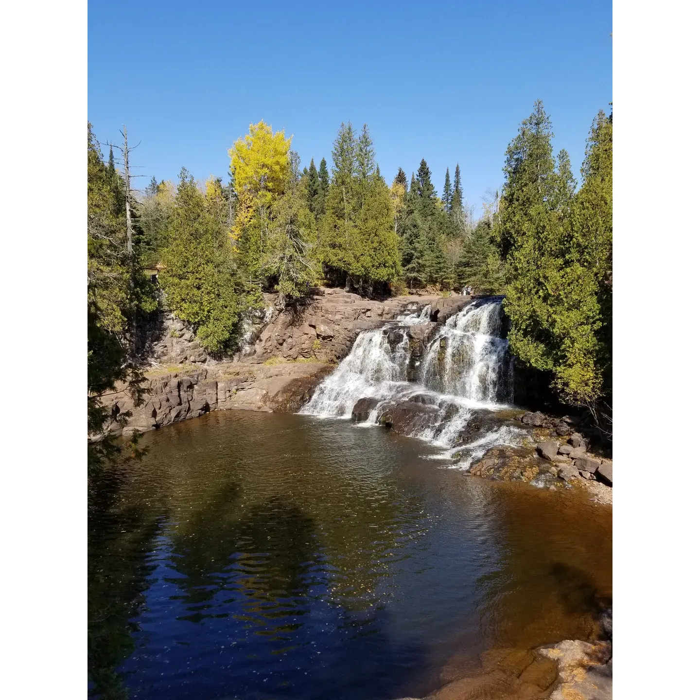 Located along the majestic shores of Lake Superior, Gooseberry Falls State Park Group Camp Site is a serene retreat for outdoor enthusiasts. The spacious campsites of this stunning haven offer a symphony of nature's sounds, with the soothing cadence of waves crashing against the rocky shorelines providing a tranquil backdrop to your stay.  

Guests are often captivated by the picturesque beauty that unfolds during the autumn months, with vibrant foliage transforming the landscape into an artist's palette of golds and reds. Although the crisp evenings invite a layer of protective clothing, the experience is worth the chill as the park becomes an autumnal wonderland.

A stone's throw away from the campsite, the thunderous Gooseberry Falls presents an awe-inspiring display of natural power and beauty. The proximity allows for easy access to the falls, making it possible for visitors to bask in the calming roar of cascading water without venturing far from their campsite. The prime months of May through June are often recommended for visiting, offering an ideal climate for outdoor activities and overnight stays.

Esteemed as one of the finest state parks in the region, it brims with joyful possibilities like the ample play areas that are a hit among children and the scenic trails offering breathtaking views that are adored by visitors of all ages. Whether seeking an adventurous group outing or a peaceful retreat into nature’s embrace, this park serves as a splendid escape and an unforgettable group camping experience. Description by ChatGPT.