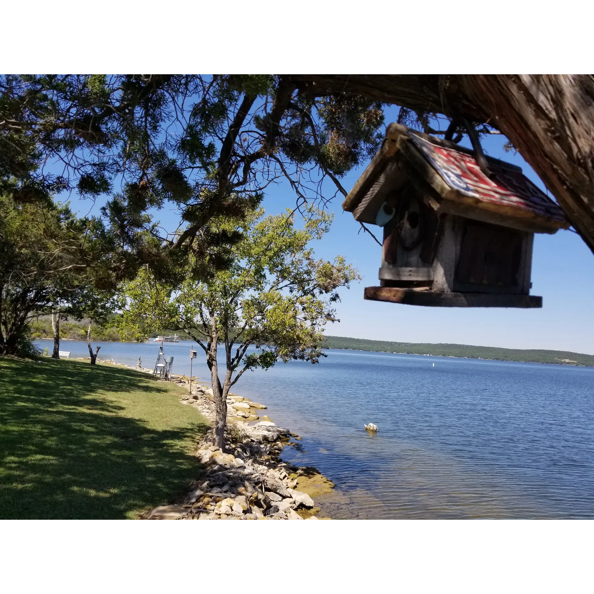 Surrounded by the tranquil beauty of rolling parkland, Possum Kingdom State Park offers a serene escape that delights outdoor enthusiasts. Shady Grove site #52 is a haven for those seeking a picturesque retreat where the harmonious blend of nature's colors and sounds creates a tapestry of peace and fun. This particular site is acclaimed for its superbly maintained greenspaces, inviting visitors to relax and rejuvenate in a pristine setting.

Families and friends gather here to take advantage of the sparkling swimming area, where the water glistens under the Texas sun—a perfect spot for cooling off and making a splash. For the little adventurers, there's an engaging playground equipped with swings, a slide, and a basketball court, ensuring that kids of all ages have plenty of activities to keep them entertained.

Angling enthusiasts can cast a line from the welcoming fishing pier, which is a favorite for both novice and experienced fishers alike. The pier is an idyllic spot to while away the hours in the pursuit of the catch of the day or simply to enjoy the panoramic views of the expansive lake.

Visitors to Shady Grove site #52 relish the opportunity to immerse themselves in the serenity of the great outdoors, forging memorable experiences and connections. Whether seeking solitude or eager to socialize with like-minded nature lovers, this gem within Possum Kingdom State Park is an optimal choice. A visit here promises a very nice experience, filled with beauty, peace, and enjoyment that has been capturing the hearts of park-goers for decades. Description by ChatGPT.