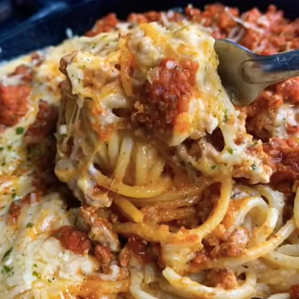 Million Dollar Spaghetti is a decadent and comforting pasta dish that layers creamy cheese, savory meat, and rich tomato sauce, all topped with a buttery crust. It's like a cross between lasagna and spaghetti, perfect for any family gathering or special occasion.