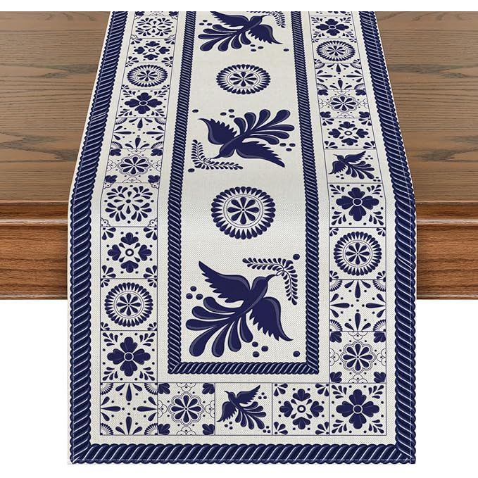 The Artoid Mode Floral Bird Dia De Los Muertos Mexican Table Runner is a vibrant and colorful piece of decoration that adds a festive touch to any kitchen or dining table.