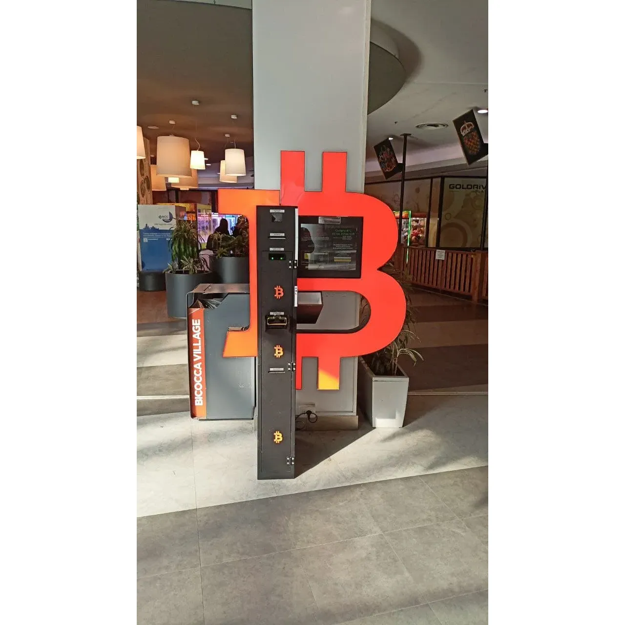 Bancomat Bitcoin ATM - Shitcoins.club is a modern and innovative financial services provider that facilitates the exchange of traditional currency for cryptocurrencies via its state-of-the-art ATMs. As a forward-thinking company keeping pace with technological advancements, Shitcoins.club has strategically positioned its ATMs in accessible locations, such as the bustling Bicocca Village. This placement allows for quick and convenient transactions for those enthusiastic about the digital currency space or simply looking to explore new financial tools.

The ATMs offer a seamless user experience, and satisfied customers have highlighted the efficiency and speed with which transactions are processed. Reports of receiving digital assets such as Ether in under 10 minutes exemplify the commitment of Shitcoins.club to provide excellent service. The ATMs serve as a symbol of progress and adaptability, reflecting the needs and interests of a modern, tech-savvy audience.

Shitcoins.club's Bitcoin ATMs operate with the aim of ensuring that customers have access to the benefits of cryptocurrencies and the growing digital economy. Their services cater to both experienced users and those new to cryptocurrencies, providing a simple and user-friendly interface for all. The presence of such ATMs within community hubs like shopping centers highlights the company’s effort to integrate cutting-edge financial services with everyday life, thereby contributing to the accessibility and mainstream adoption of cryptocurrency. Description by ChatGPT.