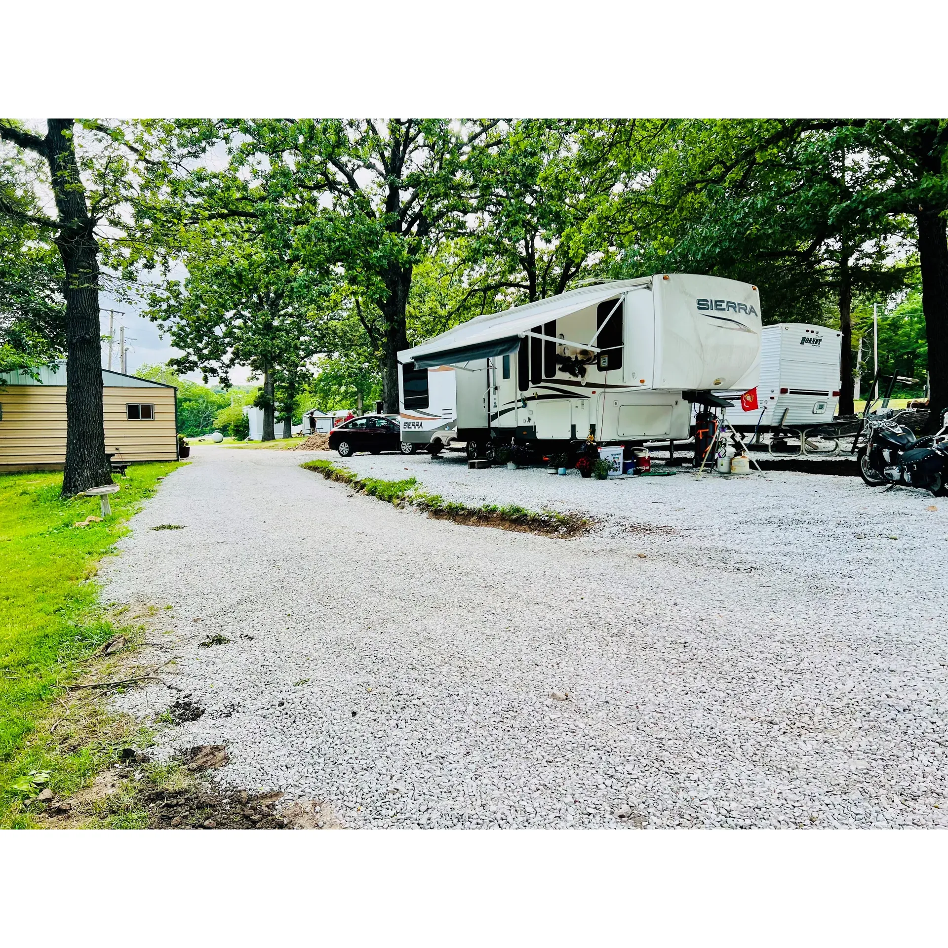 Ballard's Campground, Store & RV Park is an inviting retreat for both the spontaneous traveler and seasoned camper. Emphasizing hospitality and care, the staff is widely commended for their kindness and readiness to ensure that guests find the perfect spot that suits their needs, from spacious sites for larger rigs to cozy corners for smaller setups. 

The campsite environment is a blend of natural charm and meticulous care, graced with lush trees, serene grassy areas, and a quaint pond that provides a picture-perfect backdrop for relaxation. The grounds are continuously updated, noticeable in the freshly painted buildings and new landscaping, adding to the parks' great appeal. 

Highlighted as a go-to destination for essential outdoor amenities, Ballard's offers newly installed fire pits, grills, and a playground that promises fun for the entire family. Beyond these outdoor conveniences, the campground excels in its indoor facilities, boasting some of the most praised showers that guests describe as exceptionally clean, warm, and user-friendly, rivaling those of high-end establishments. The commitment to facility enhancement doesn't stop there — beneficiaries of this focus include a new shower house and a laundry room, enhancing the ease and comfort of your stay.

The camp store is a hub of welcoming personnel and a trove of convenables, ensuring that any item you may need is at arm's reach, affirming the campground’s dedication to convenience and service. When the sun sets, the RV park transforms into a cozy community with residents displaying fun lights and patio furniture, creating a homely ambiance that invites social interaction or peaceful nighttime retreats.

Whether passing through or seeking a getaway, Ballard's Campground, Store & RV Park presents a well-rounded experience with outstanding amenities that cater to a variety of camping preferences, all wrapped up in the embrace of excellent service and community warmth. Description by ChatGPT.